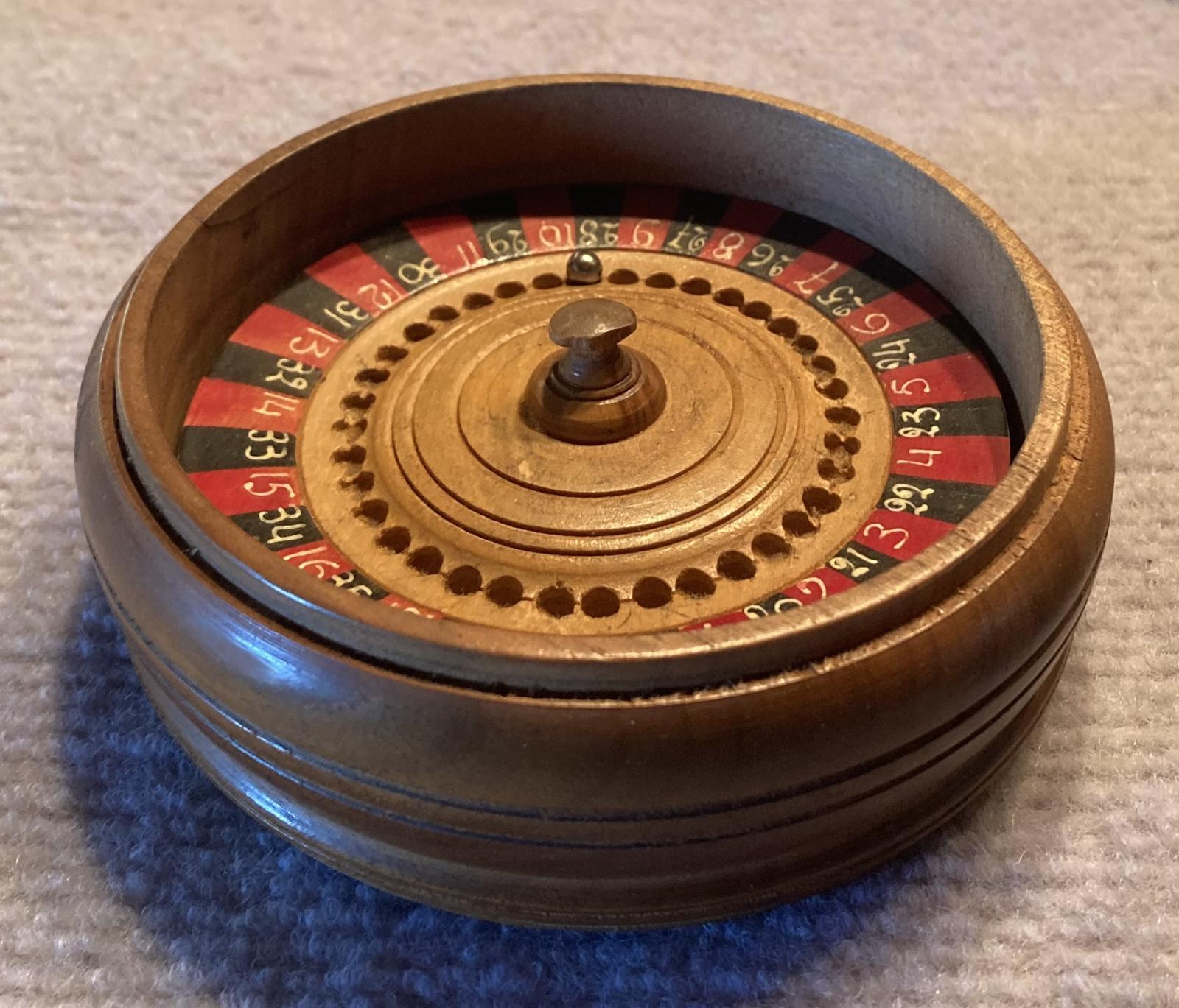 Trench art timber roulette wheel with Rising Sun badge - oblique view 