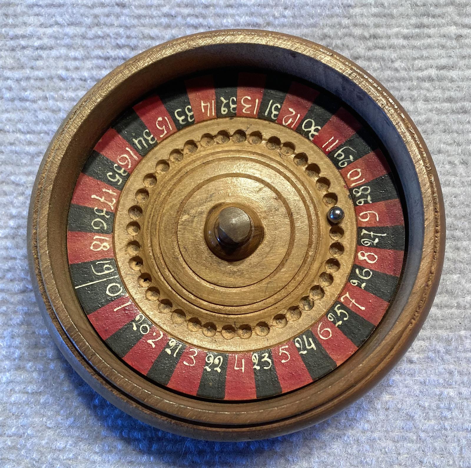 Trench art timber roulette wheel with Rising Sun badge - view from above