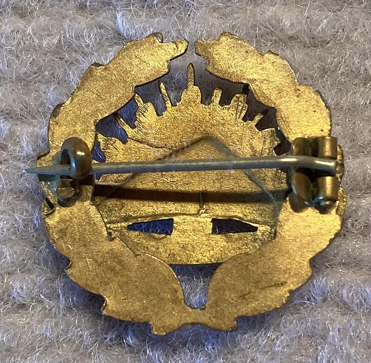 Reverse of brass and enamel Rising Sun badge sweetheart brooch
