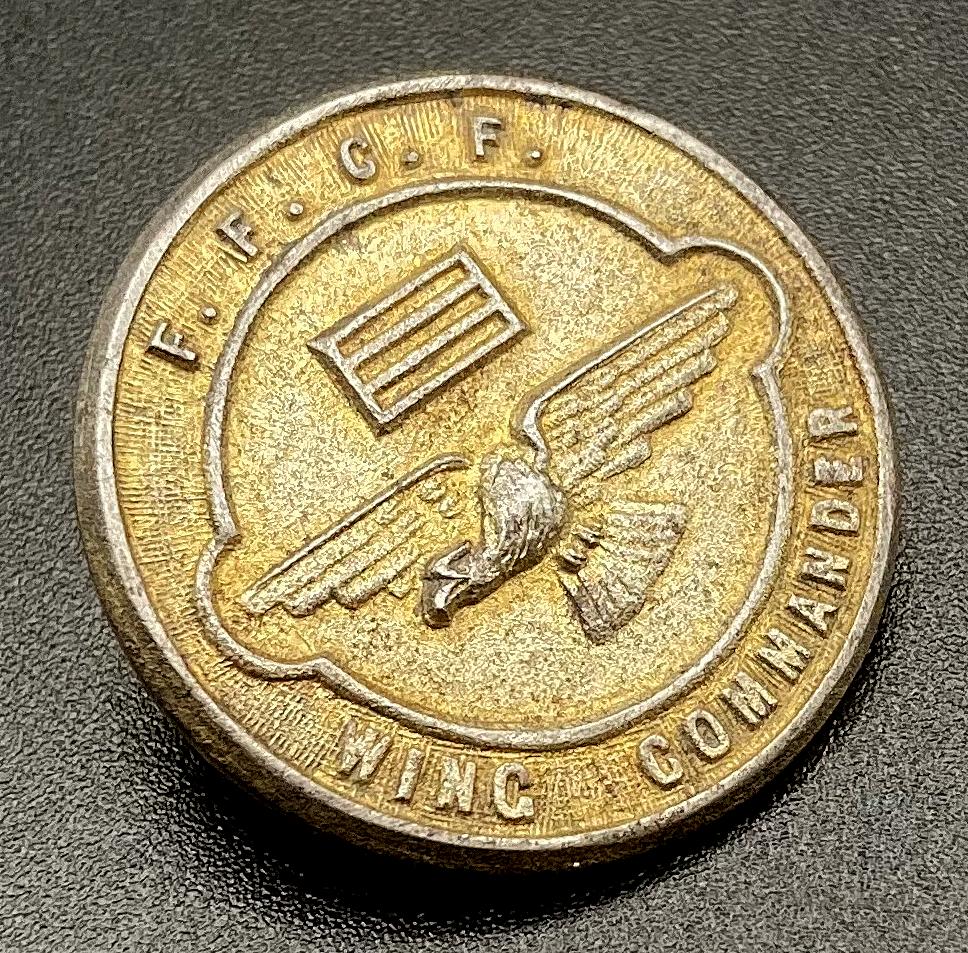 Angled view of WWII era fundraising badge - Fighting Forces Comforts Fund