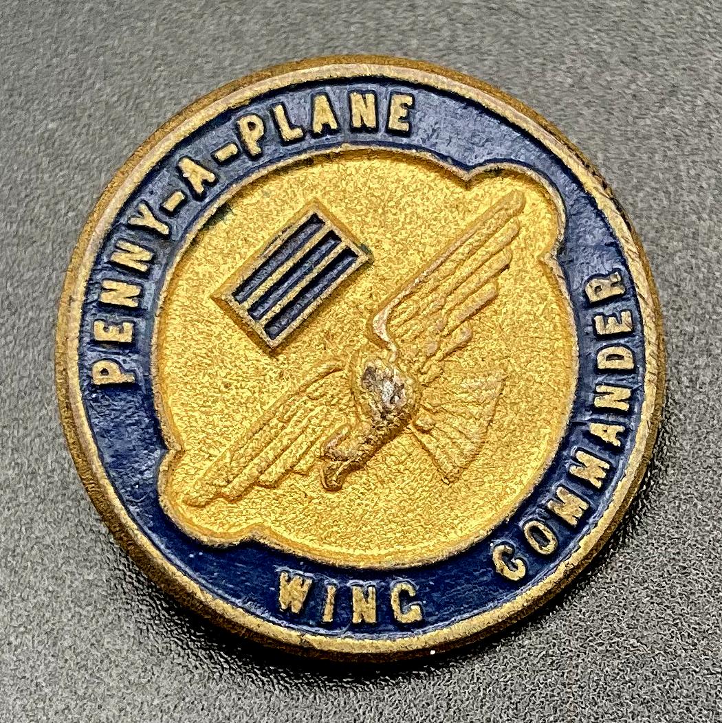 Angled view of WWII era fundraising badge - 'Penny-a-plane' appeal