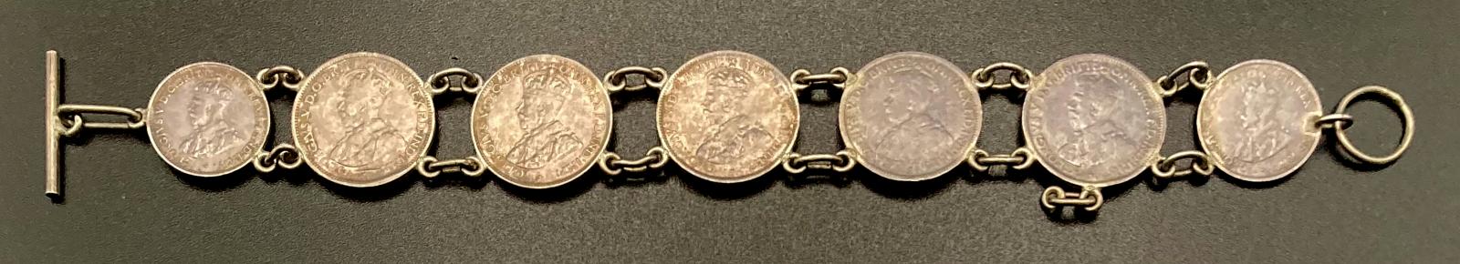 Reverse of trench art coin bracelet made from sixpences and threepences