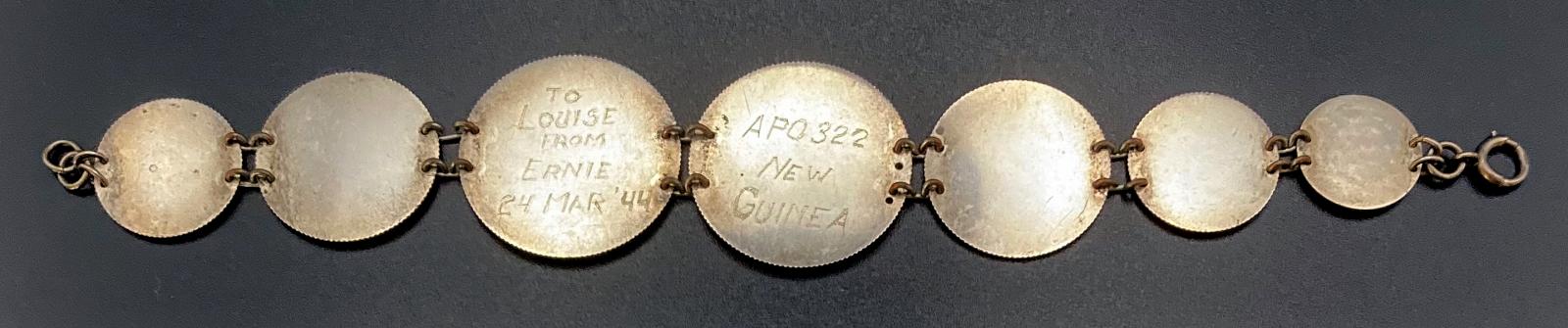 Reverse of WWII era trench art coin bracelet given to Louise by Ernie 1944
