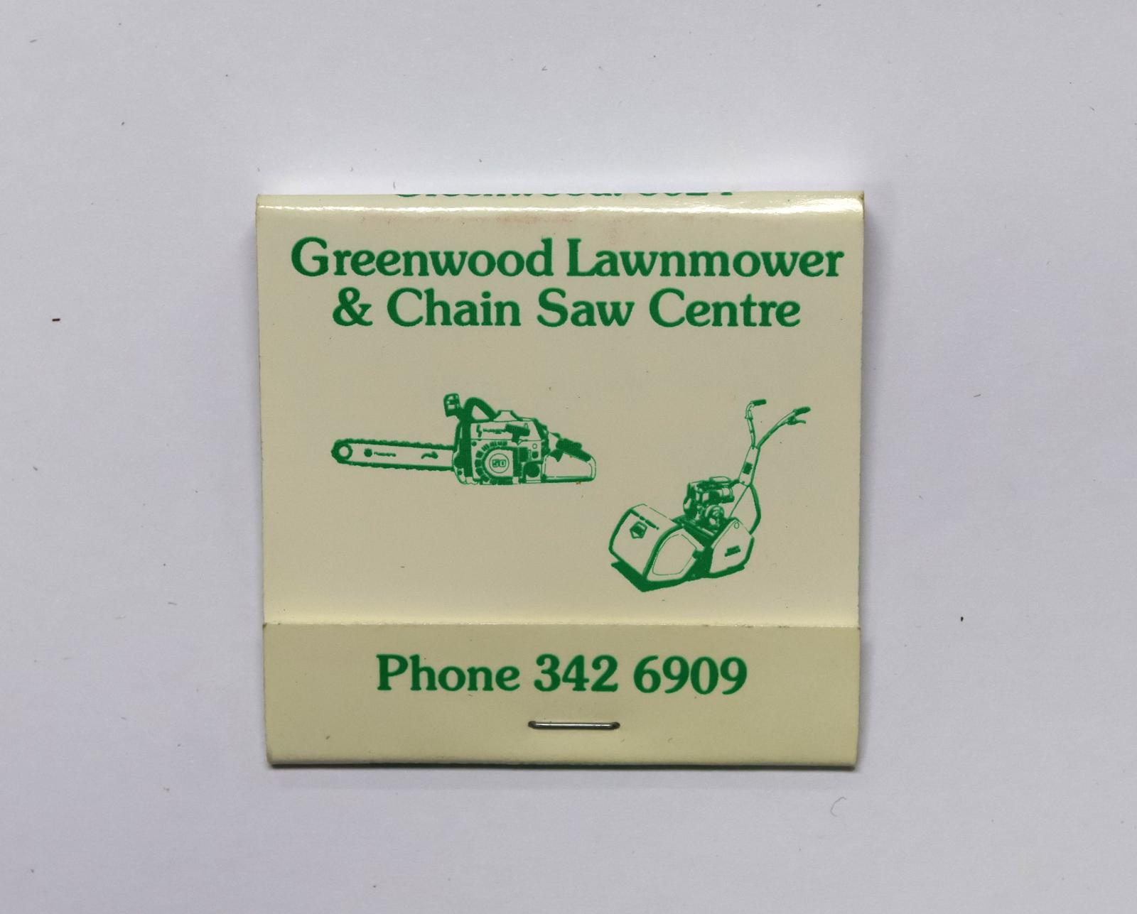 Square shaped matchbook, white background with green writing. There is a staple in the front holding the matches in place.