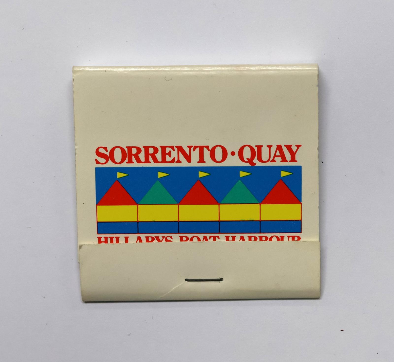Square shaped matchbook, white background with red text on the front, blue text on the reverse and on the inside.  