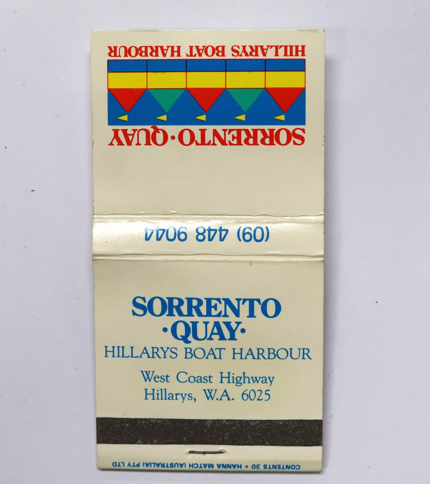 Square shaped matchbook, white background with red text on the front, blue text on the reverse and on the inside.  The back of the matchbook has a brown igniting panel. 