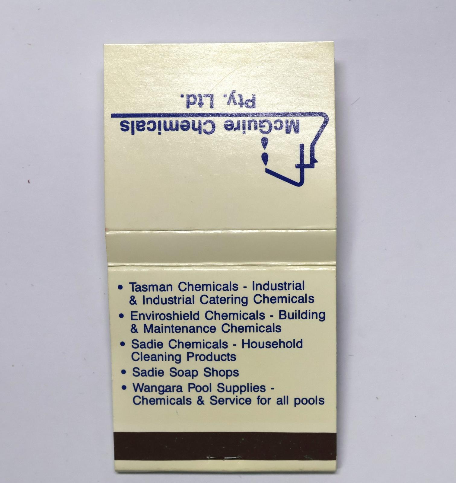 Square shaped matchbook, white background with blue text. The back of the matchbook has a brown igniting panel. 