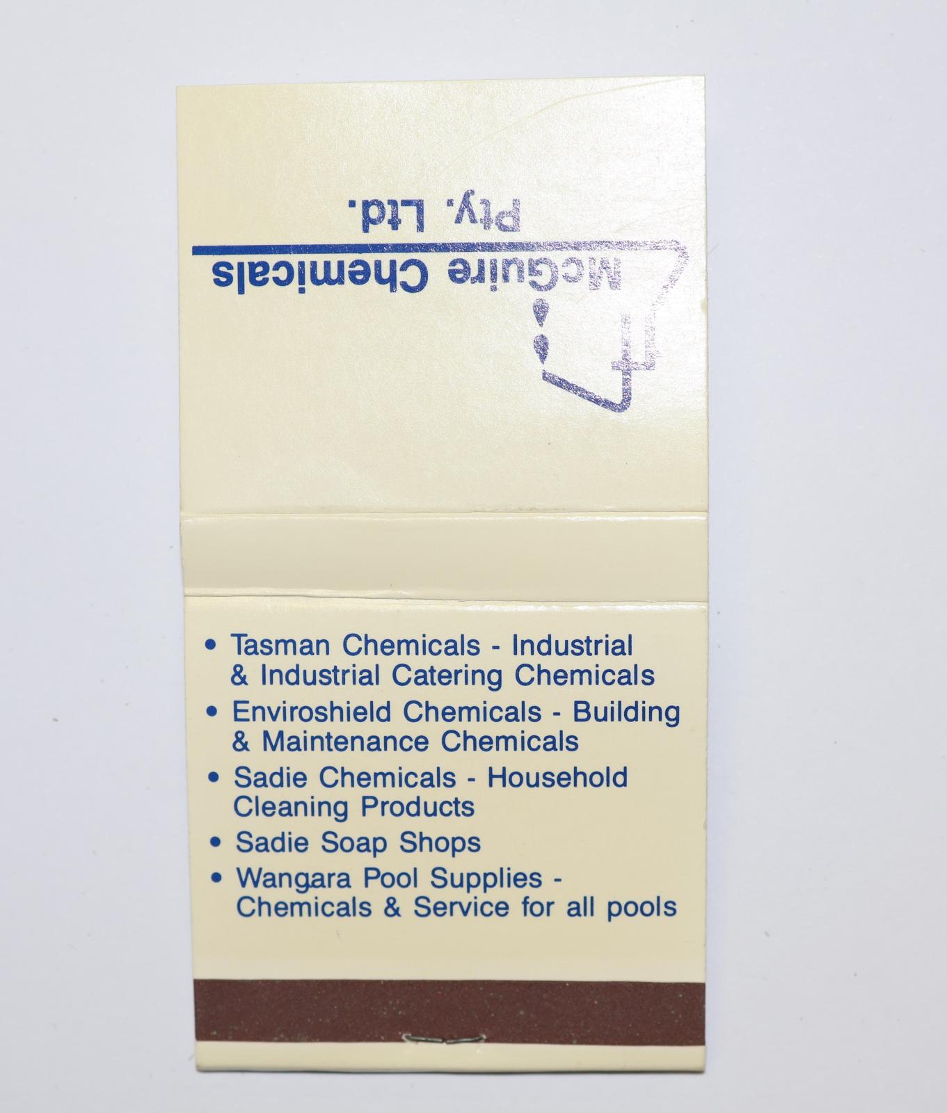 Square shaped matchbook, white background with blue text. The back of the matchbook has a brown igniting panel. 