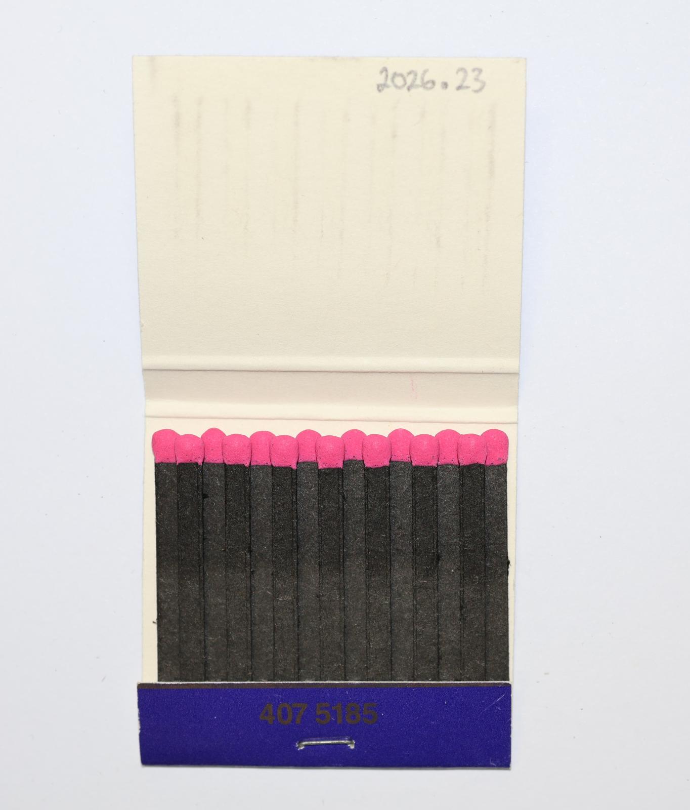 The inside has 15 black matchsticks with pink match heads.  