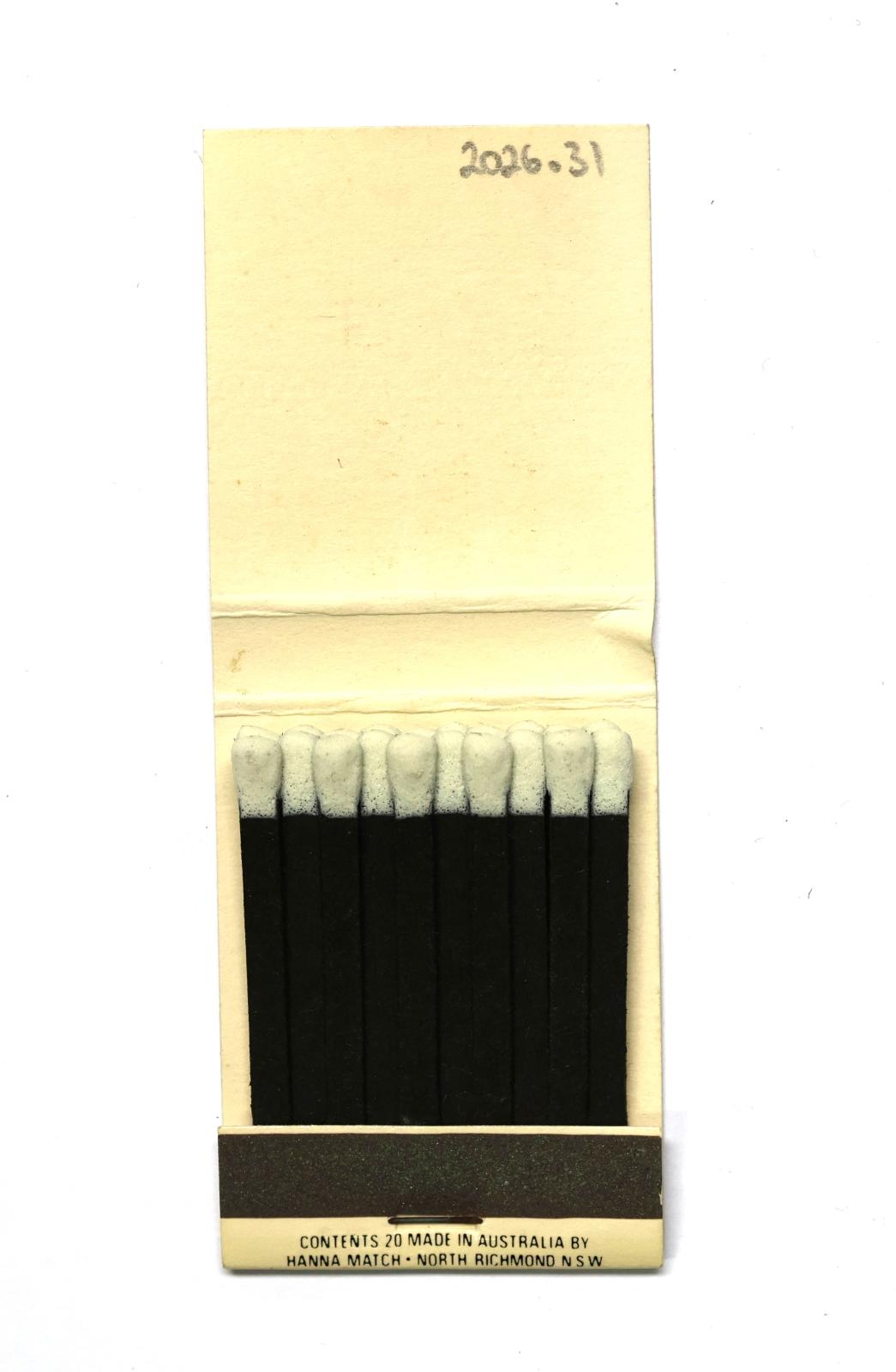 The inside has 20 black matchsticks with white match heads.