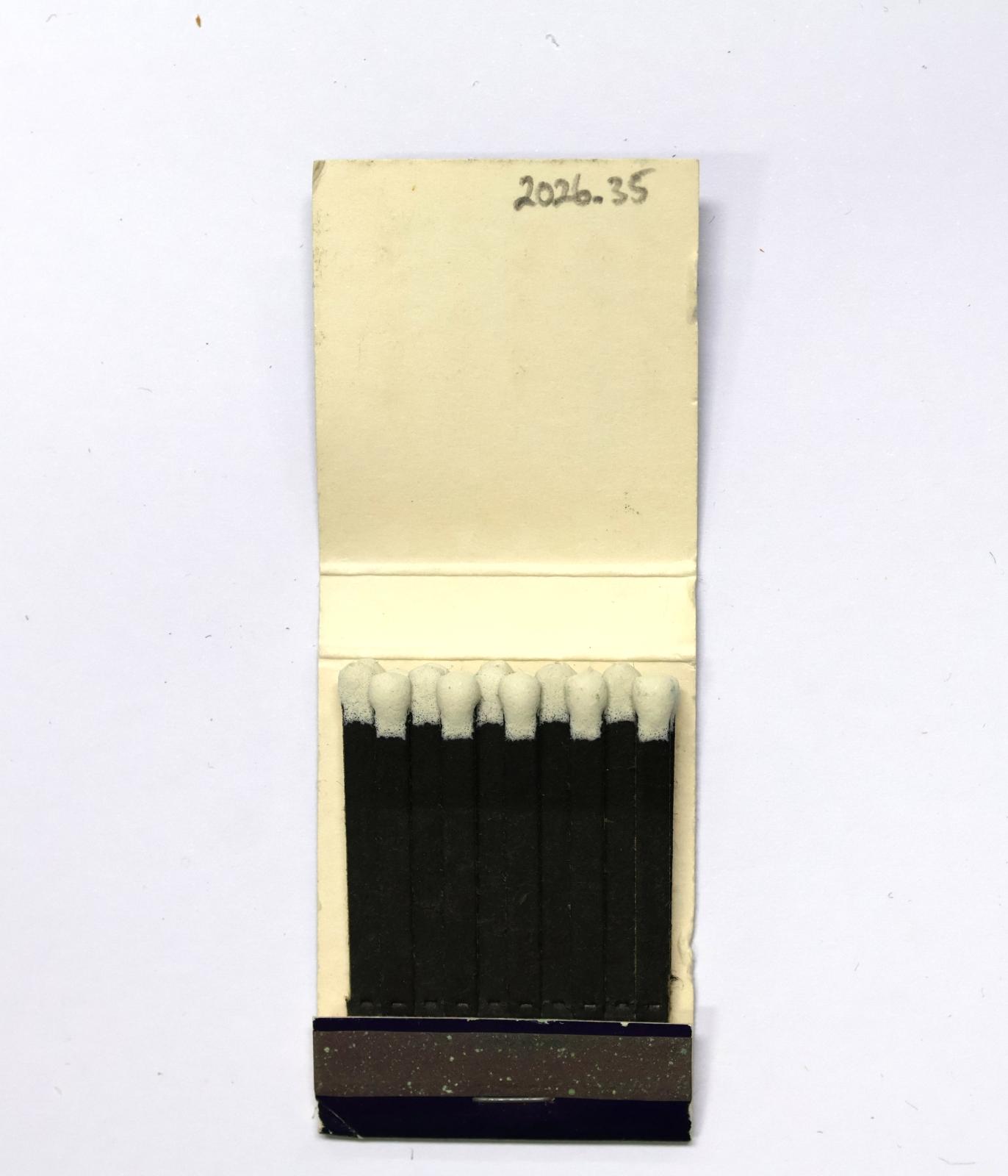 The inside has 20 black matchsticks with white match heads.