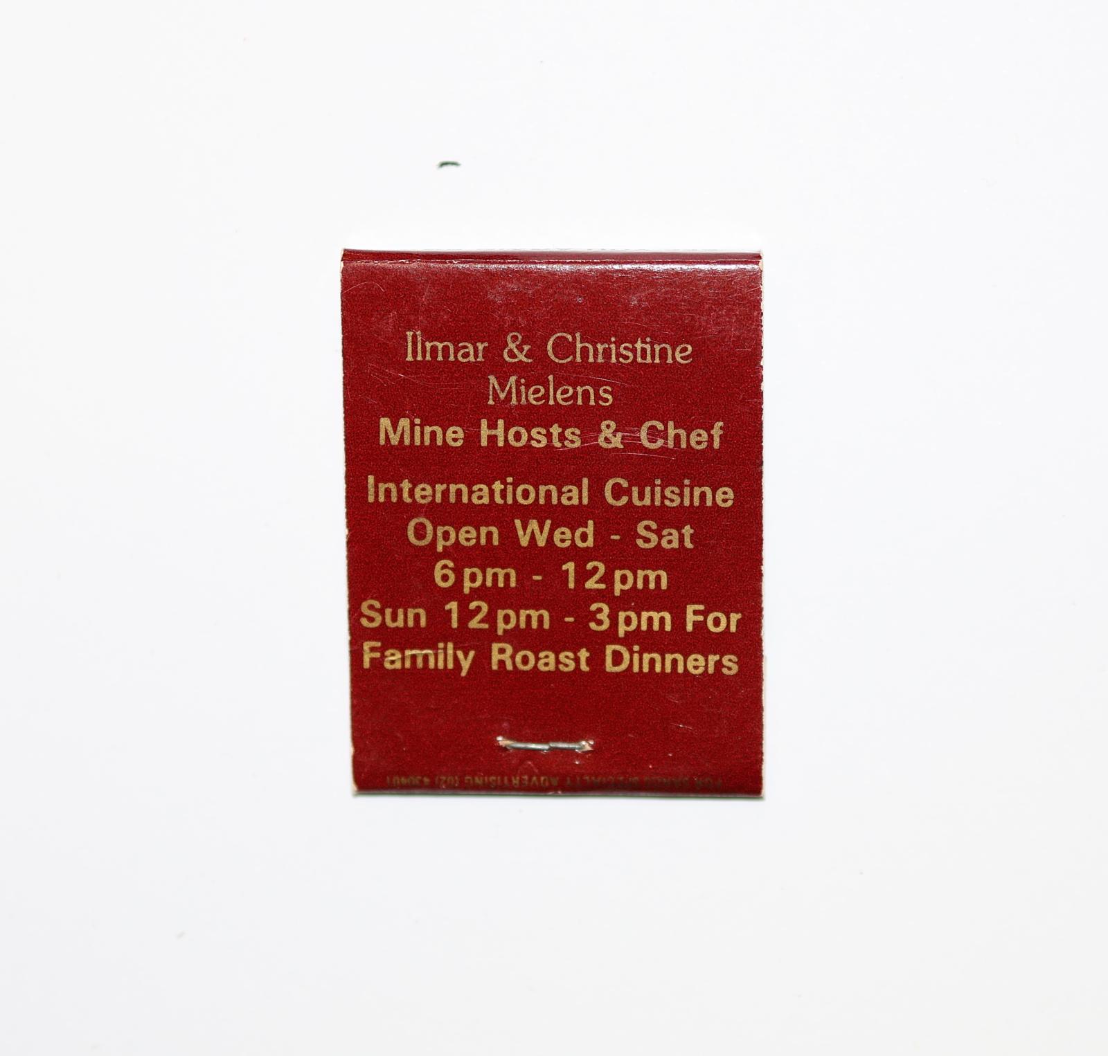 Rectangular shaped matchbook with red background and gold text.  
