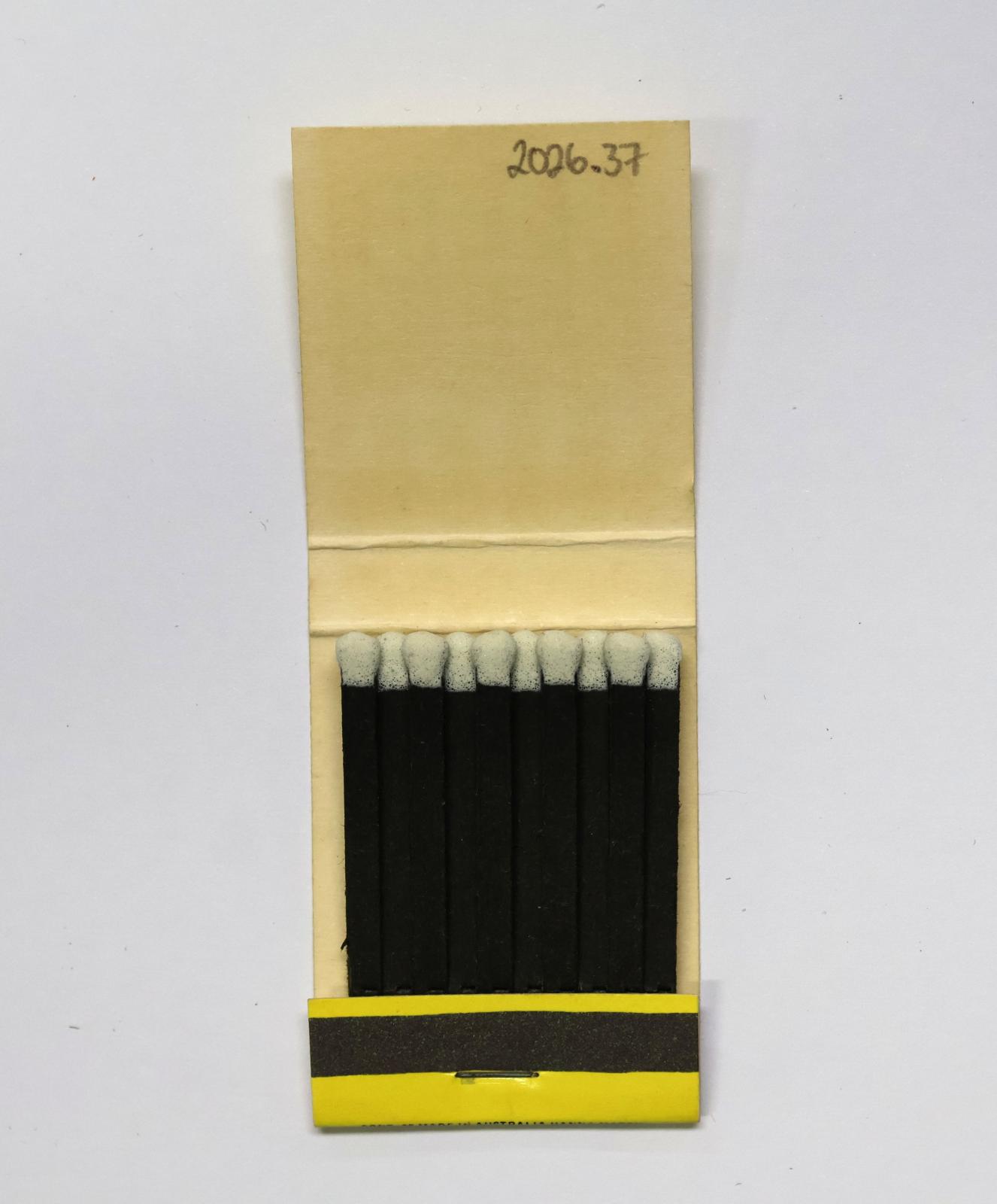 The inside has 20 black matchsticks with white match heads.