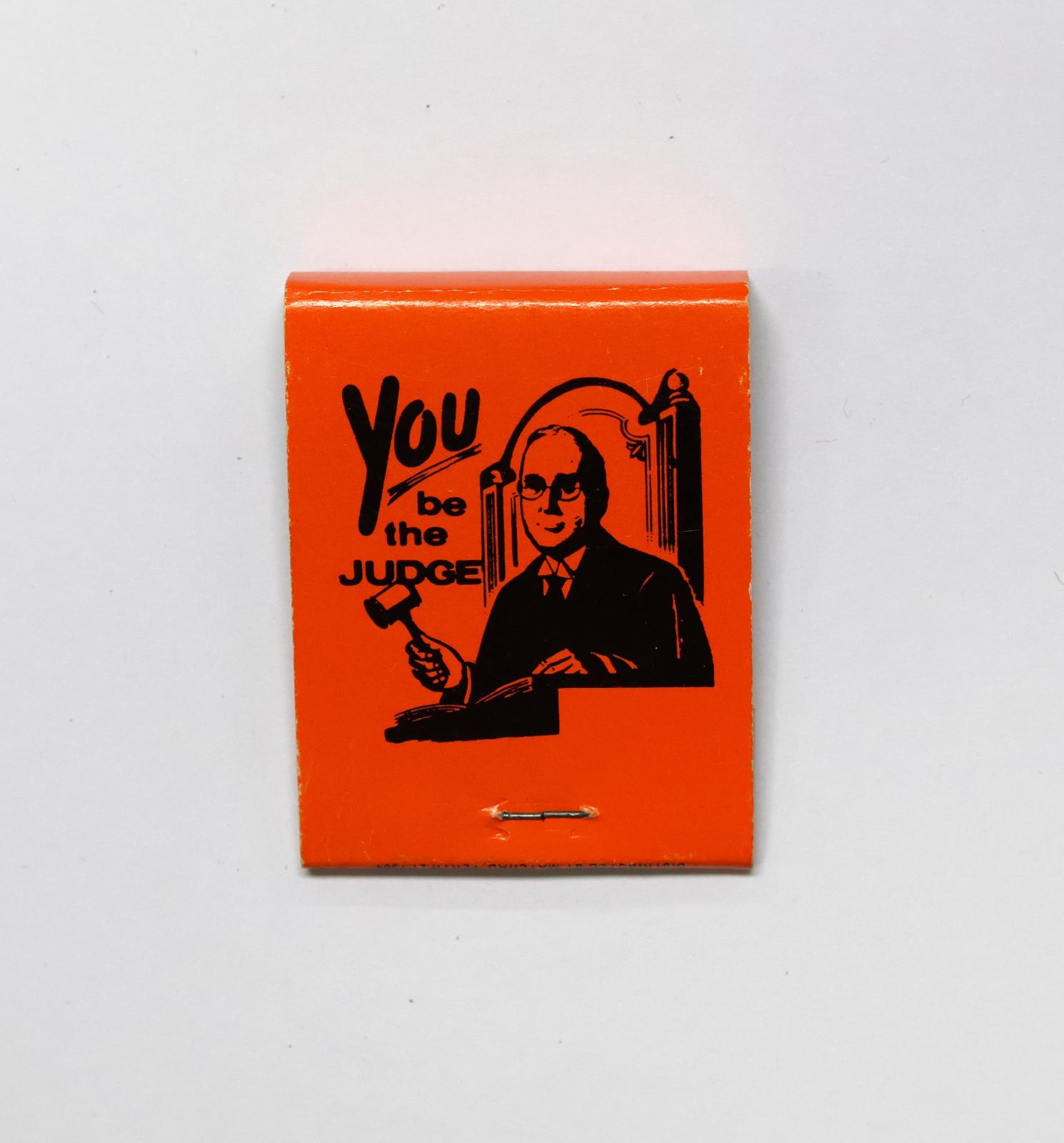 The back of the matchbook has an image of a judge with a gavel. 