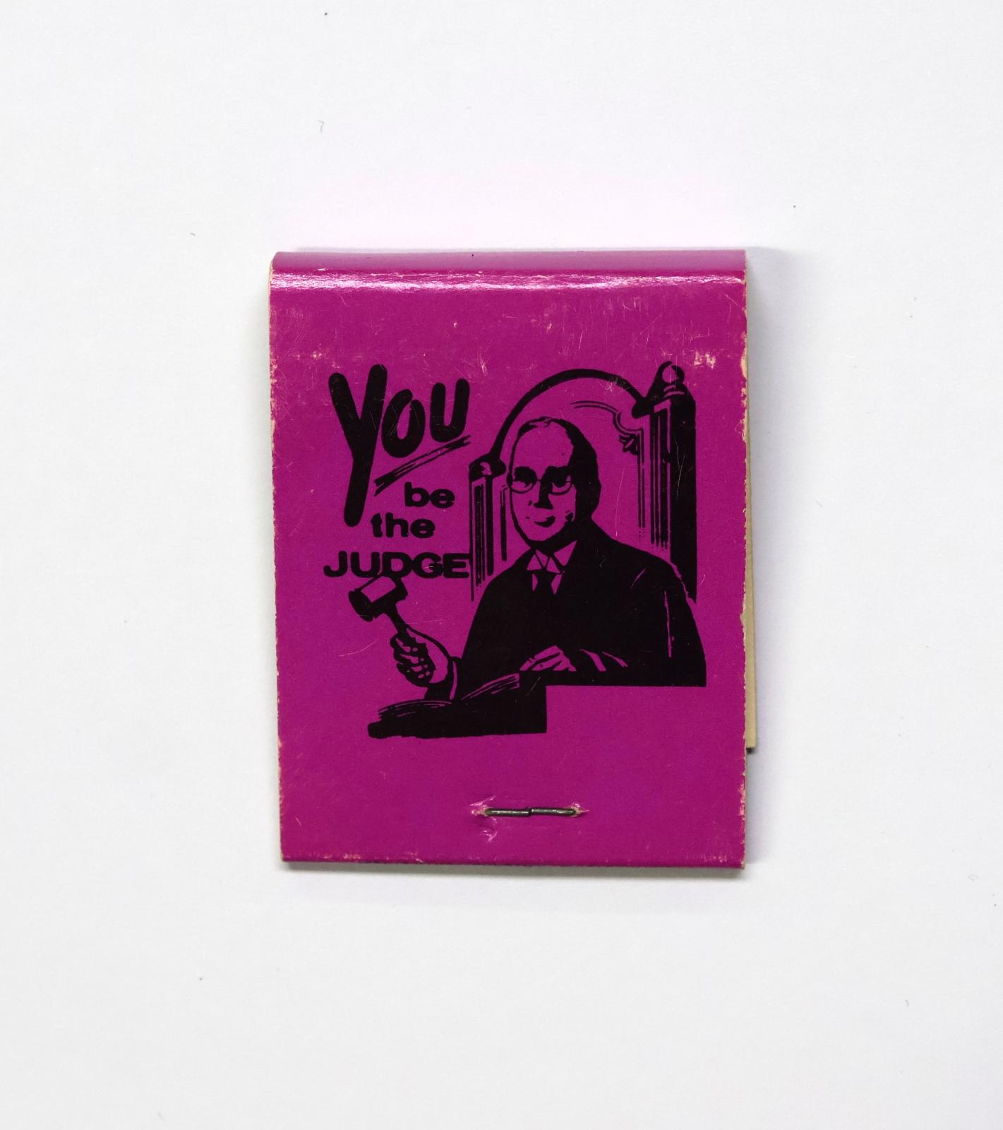The back of the matchbook has an image of a judge with a gavel. 