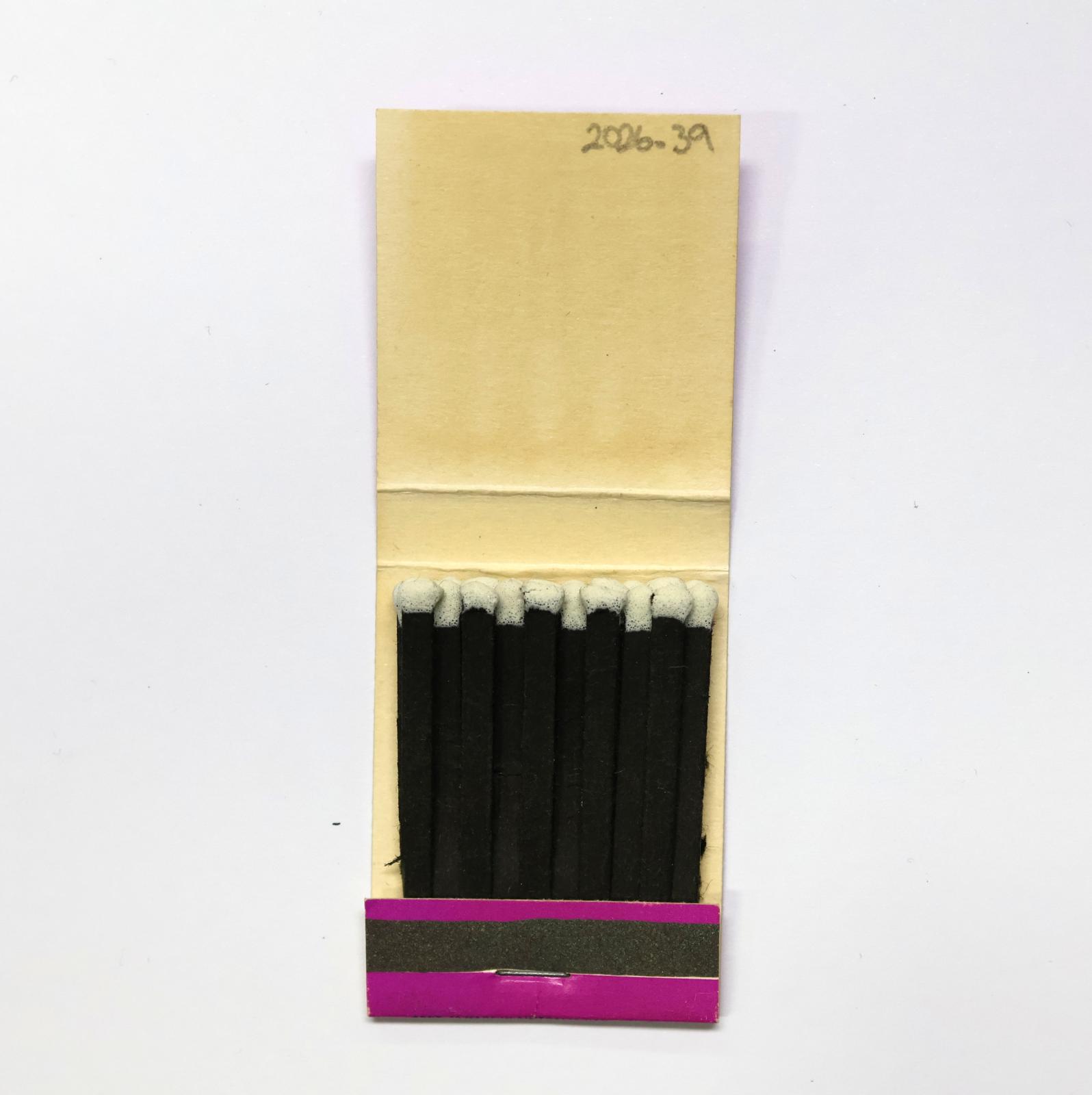 The inside has 20 black matchsticks with white match heads.