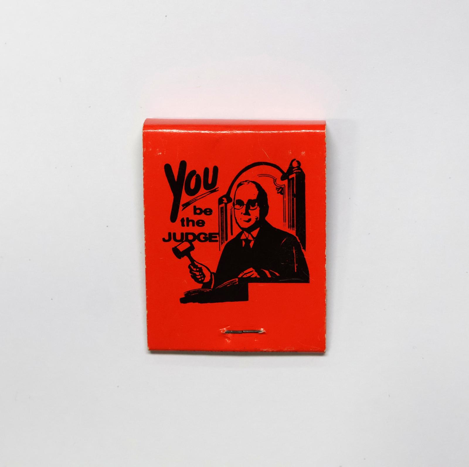 The back of the matchbook has an image of a judge with a gavel. 