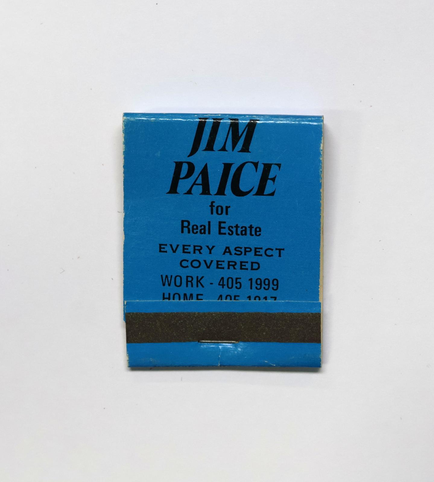 Rectangular shaped matchbook with blue background and black text.  The front of the matchbook has a grey igniting panel.