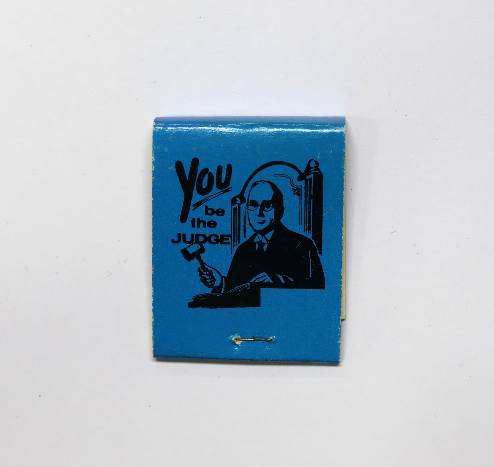 The back of the matchbook has an image of a judge with a gavel. 