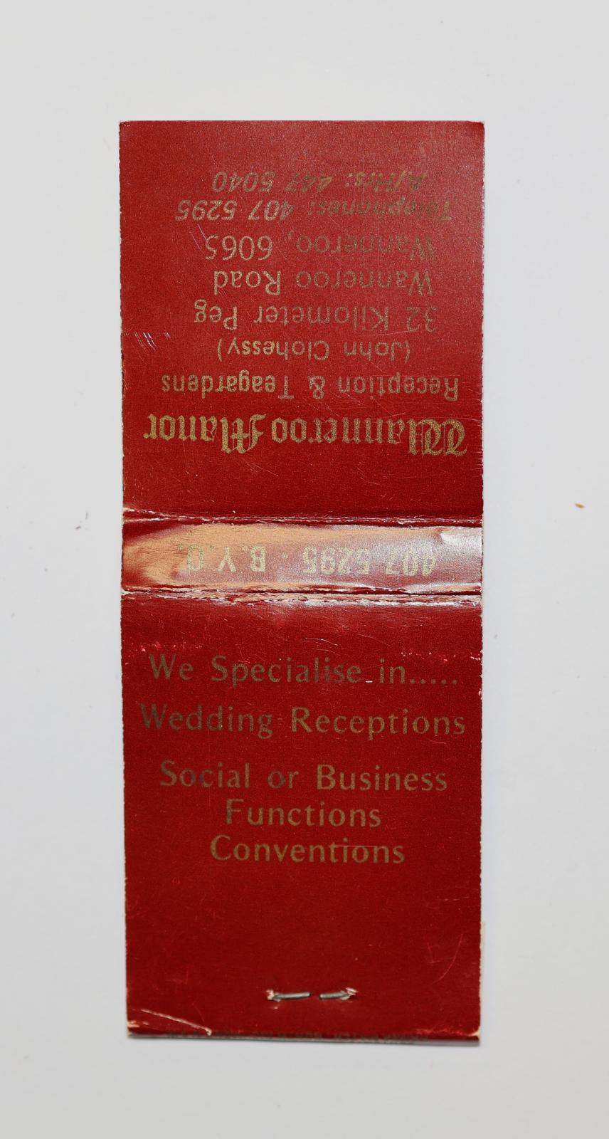Rectangular shaped matchbook with dark red background and gold text. The front of the matchbook has a grey igniting panel. The front and back of the matchbook has text.