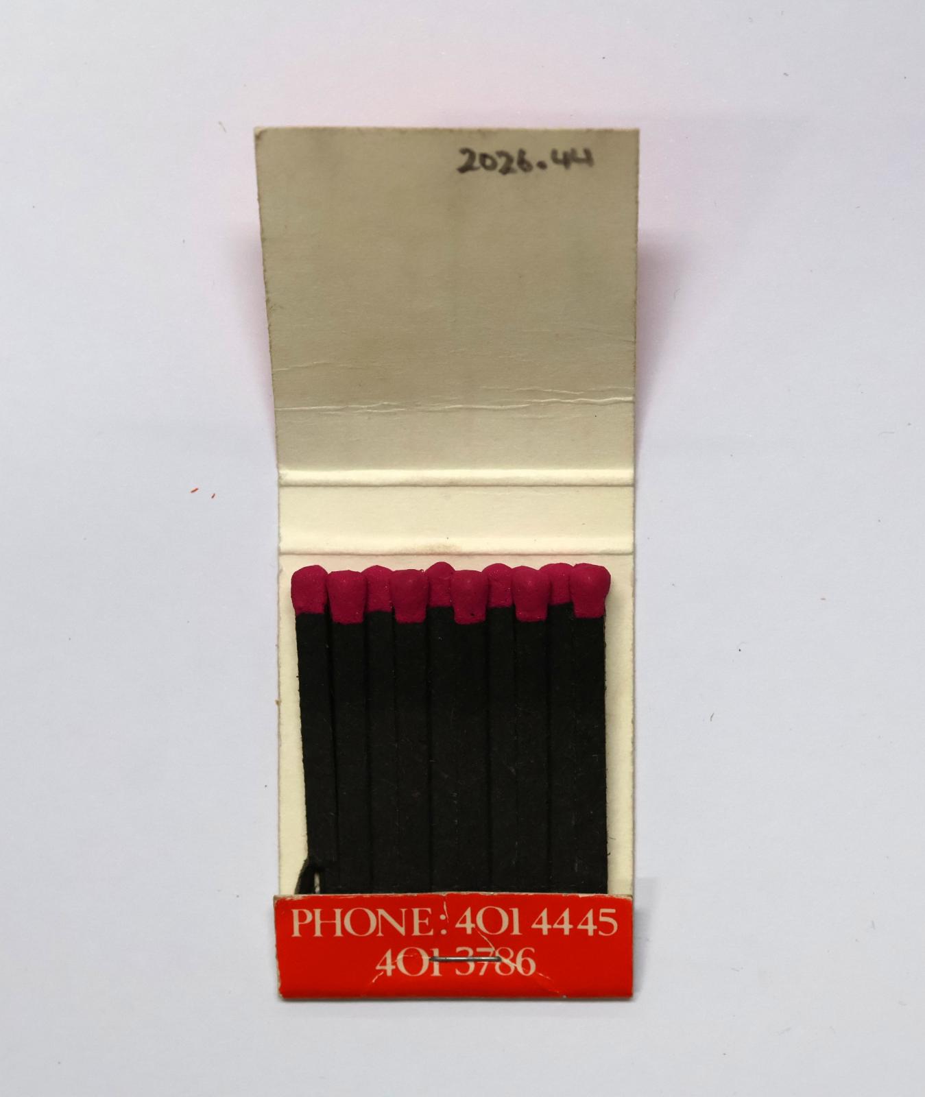 The inside has 20 black matchsticks with pink match heads.