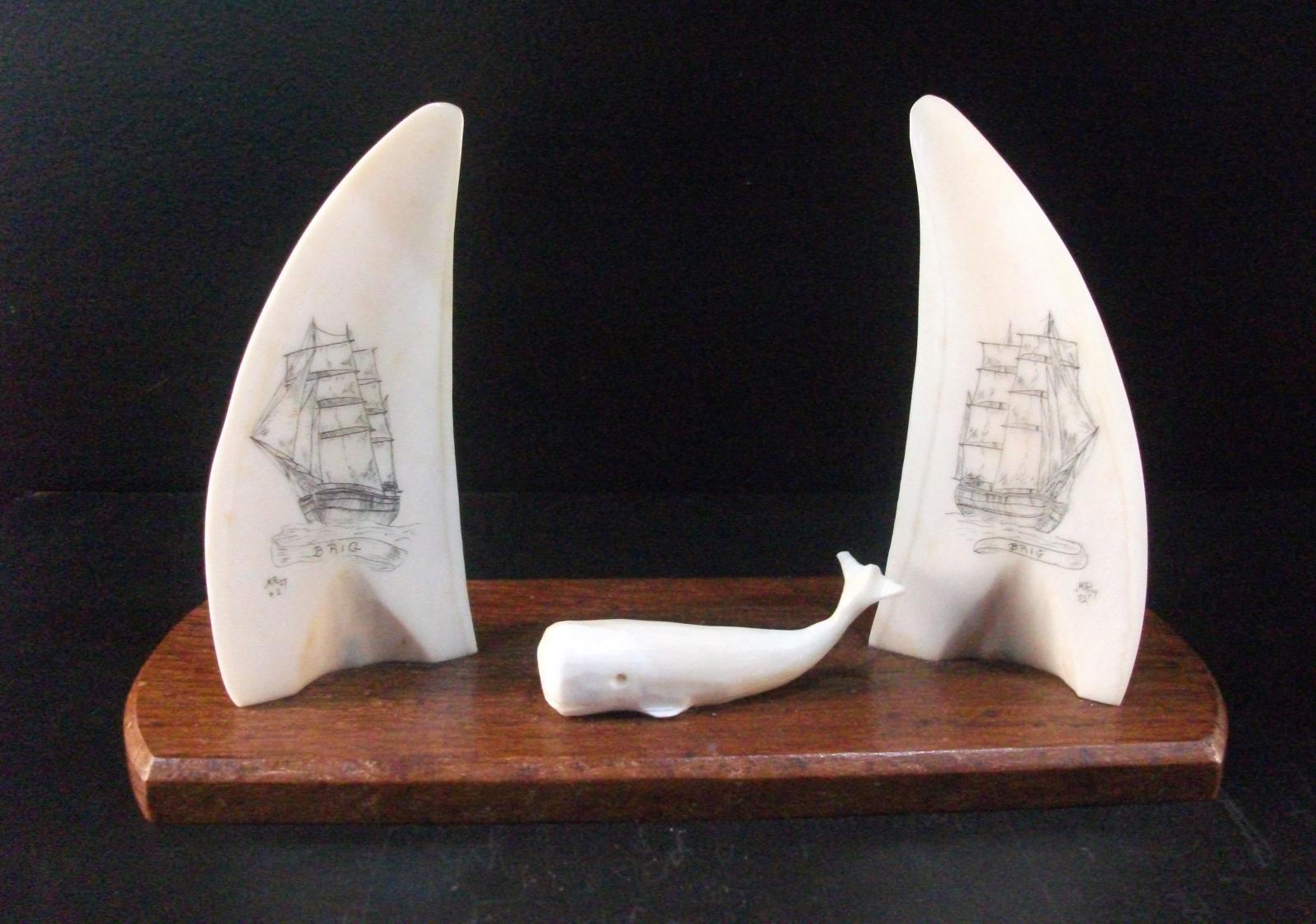 Two teeth with historic sailing ships and a sperm whale on wooden mount