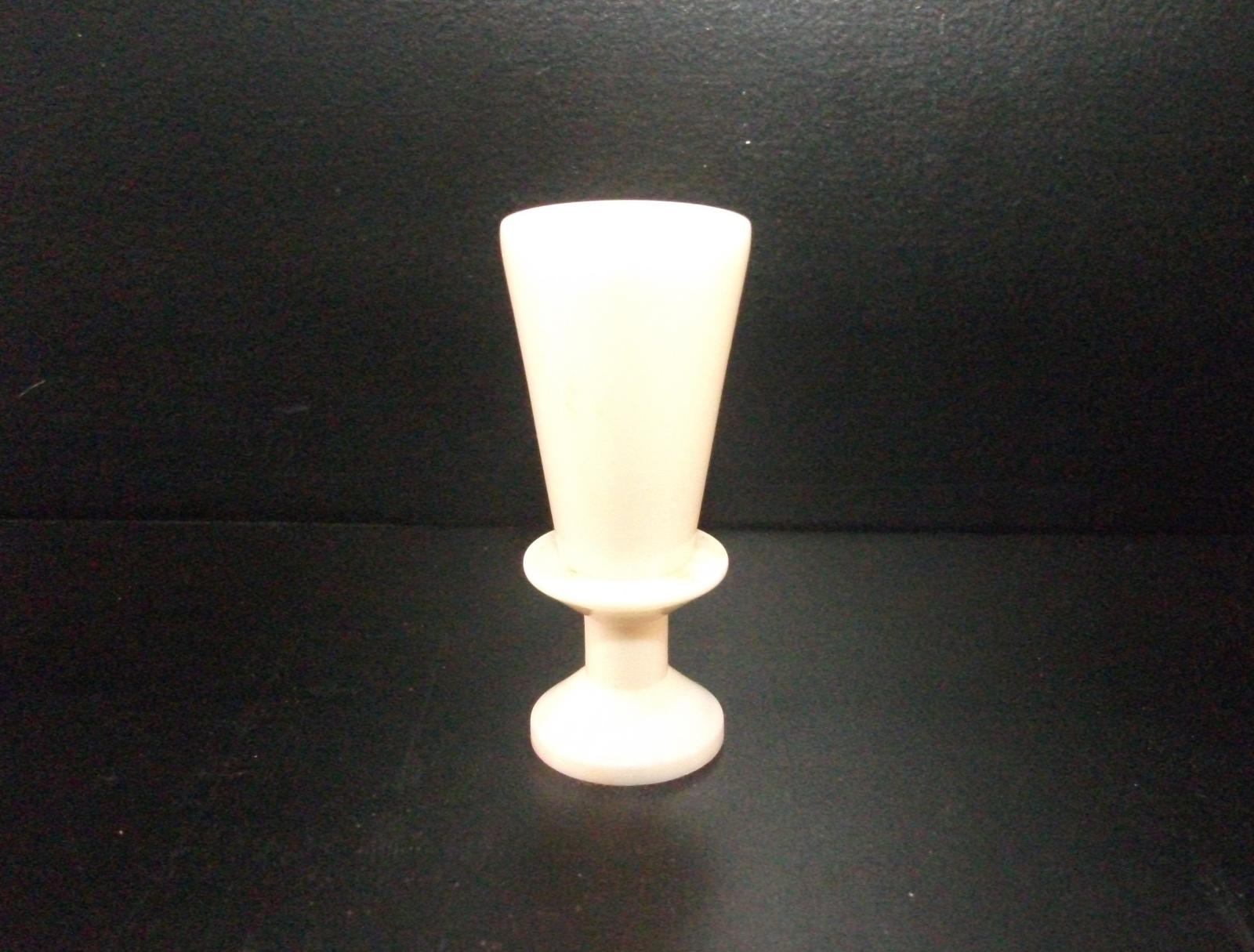 One of pair of turned ivory candlestick holders.