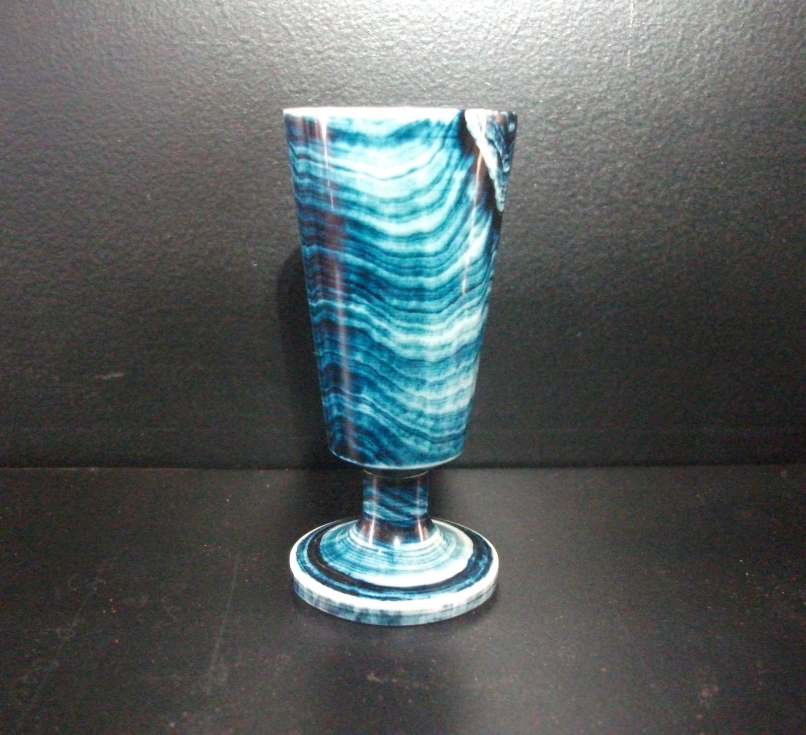 Tumbler made from whale bone and stained to reveal growth rings.