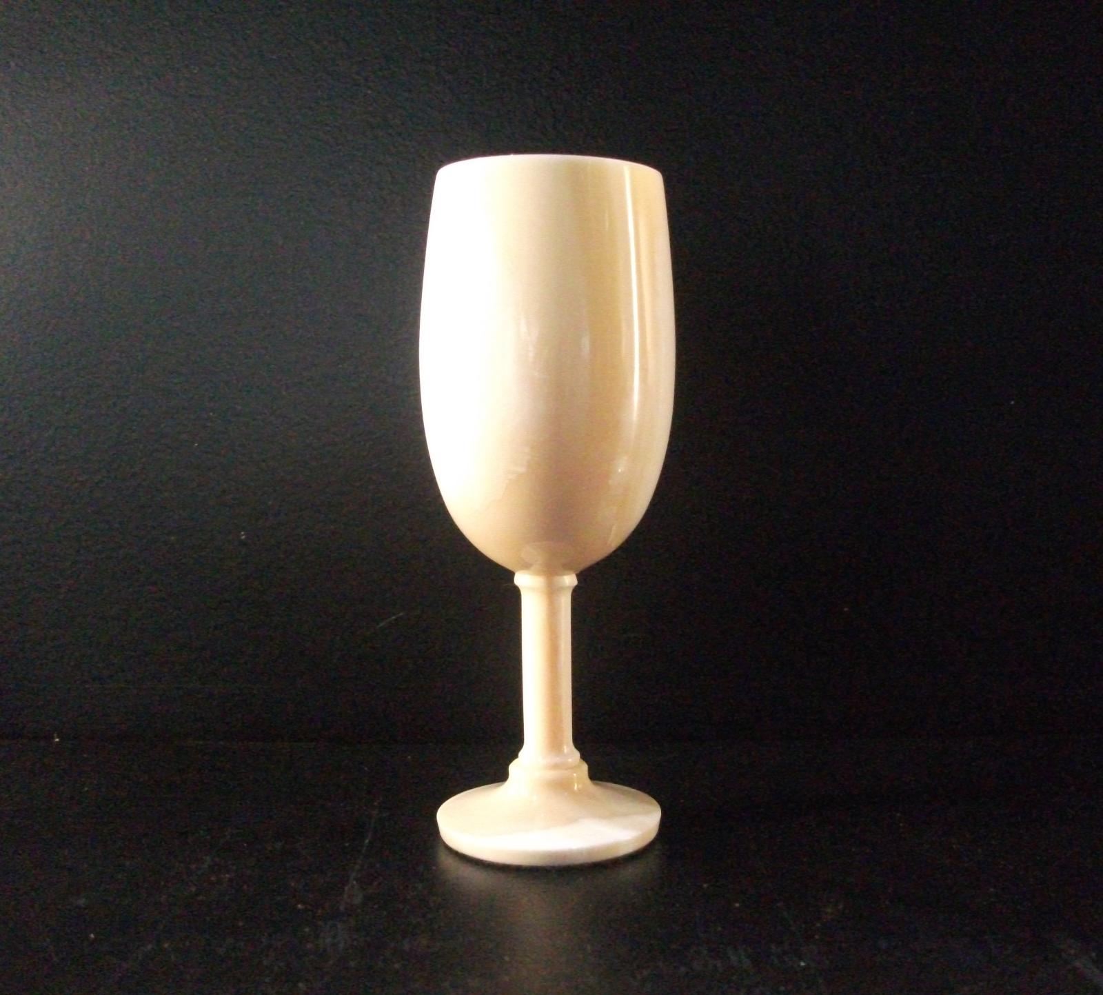 One of set of 6 turned ivory wine glasses