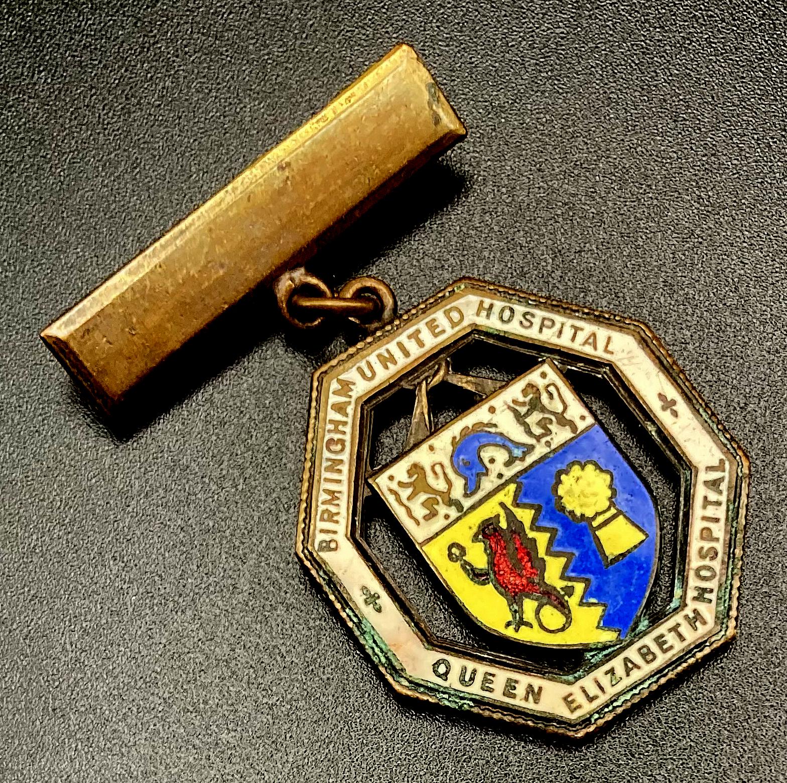 Angled view of Birmingham United Hospital Queen Elizabeth Hospital badge presented to Nurse E.E. Webb