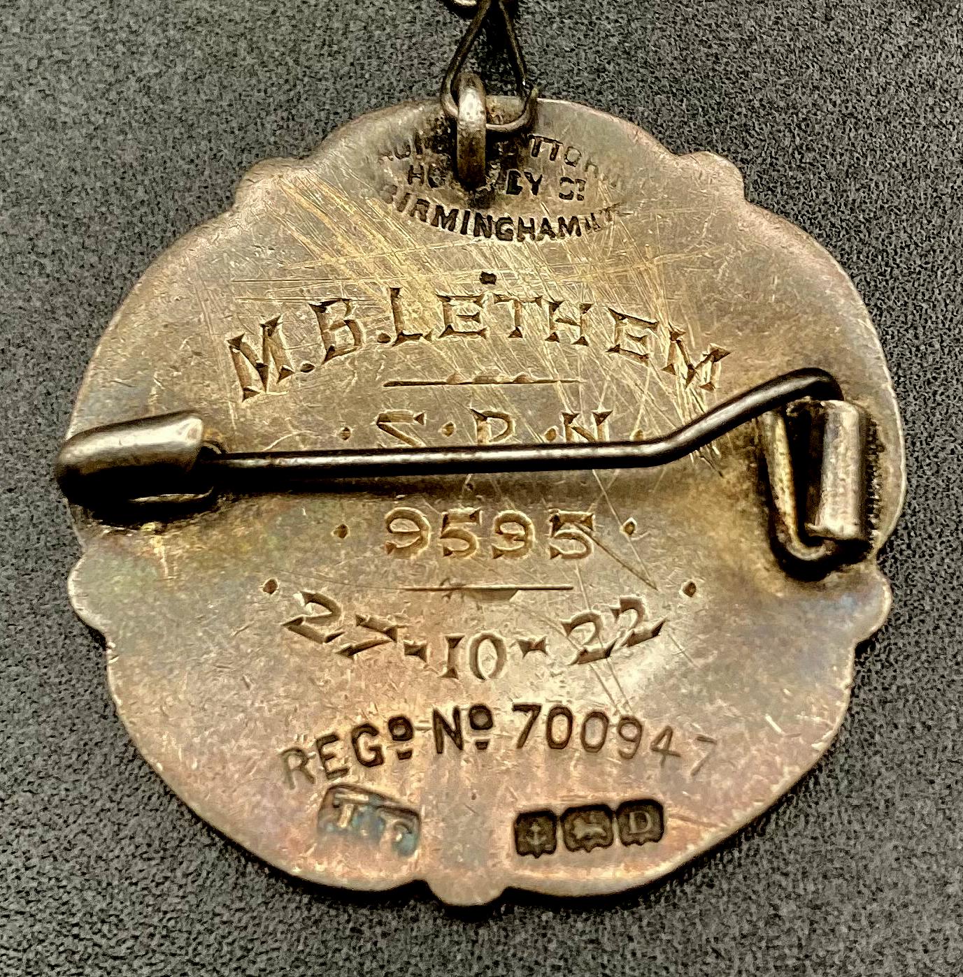 Close up of the reverse of The General Nursing Council for England and Wales badge presented to M.B. Lethem 1922