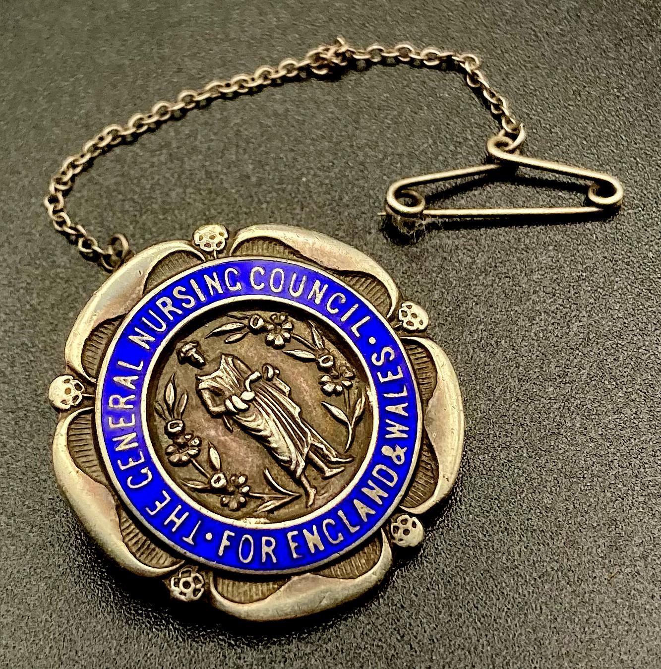 Angled view of The General Nursing Council for England and Wales badge presented to M.B. Lethem 1922