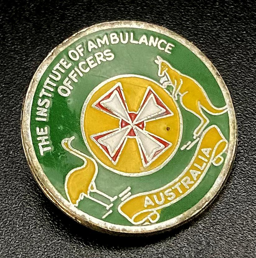 Angled view of The Institute of Ambulance Officers Australia enamel badge