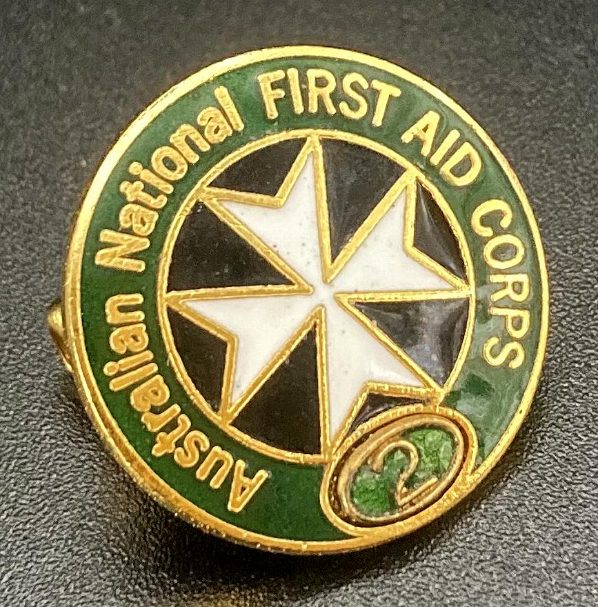 Angled view of Australian National First Aid Corps enamel badge