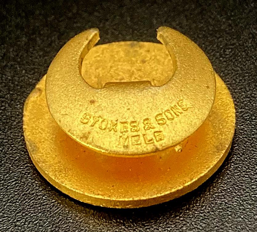 Oblique view of reverse of Zinc Corporation Ambulance Association enamel badge