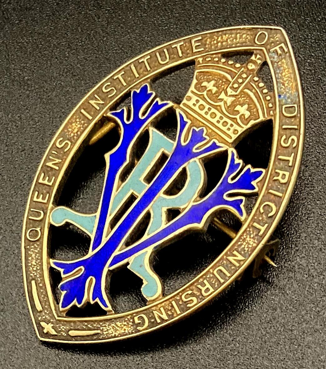 Other angled view of Queen's Institute of District Nursing badge presented to Winifred L. Bingham