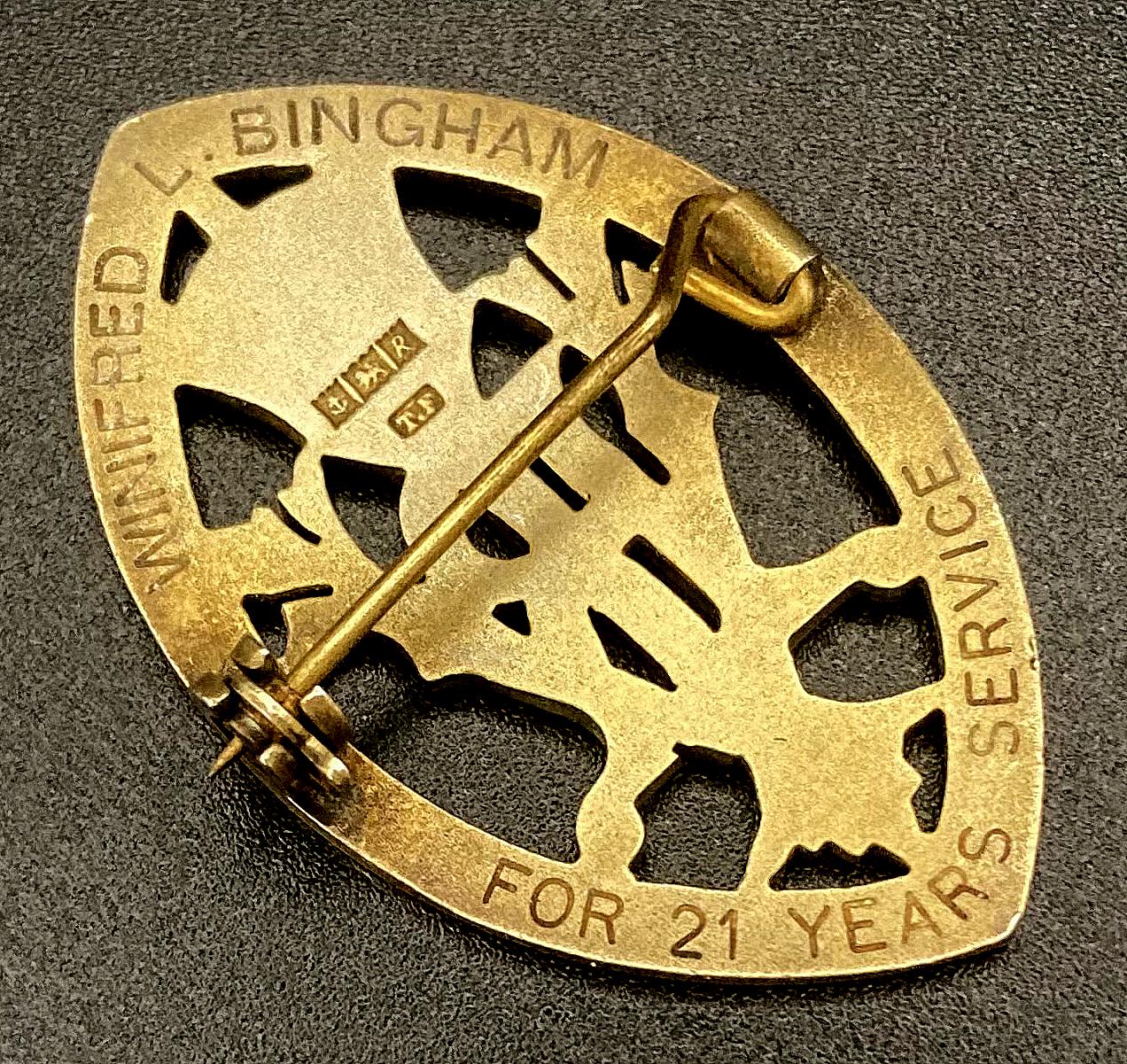 Angled view of reverse of Queen's Institute of District Nursing badge presented to Winifred L. Bingham