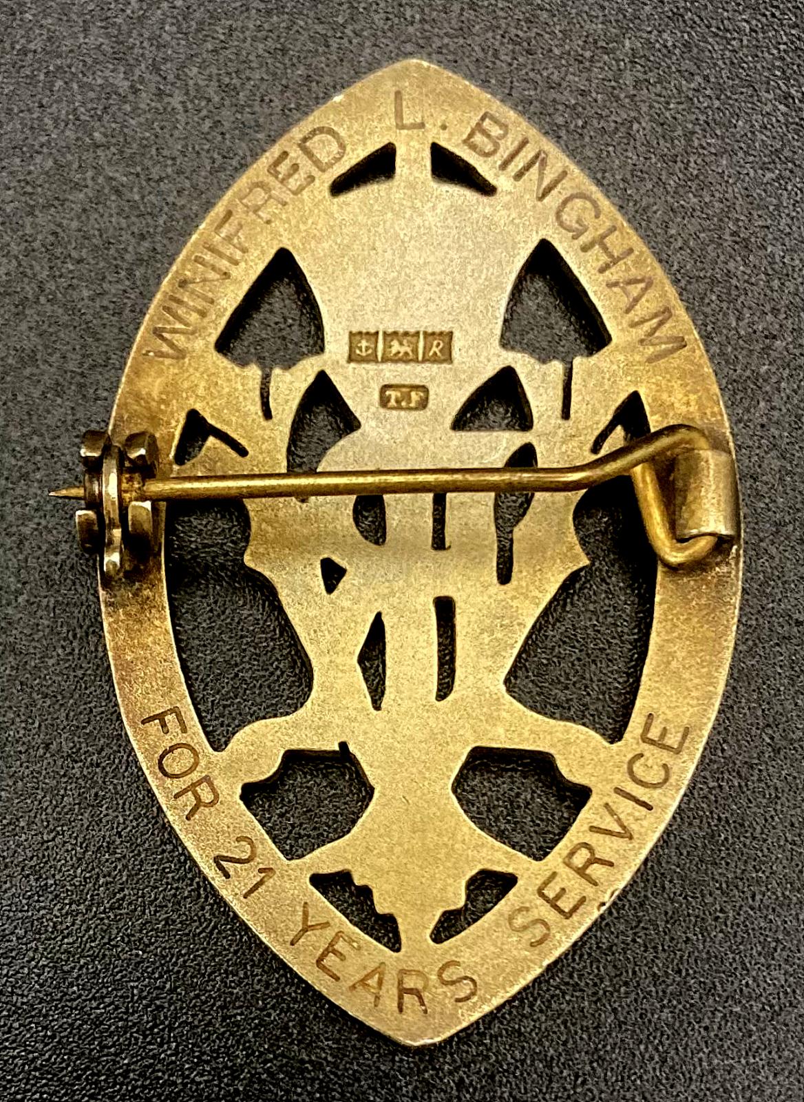 Reverse of Queen's Institute of District Nursing badge presented to Winifred L. Bingham