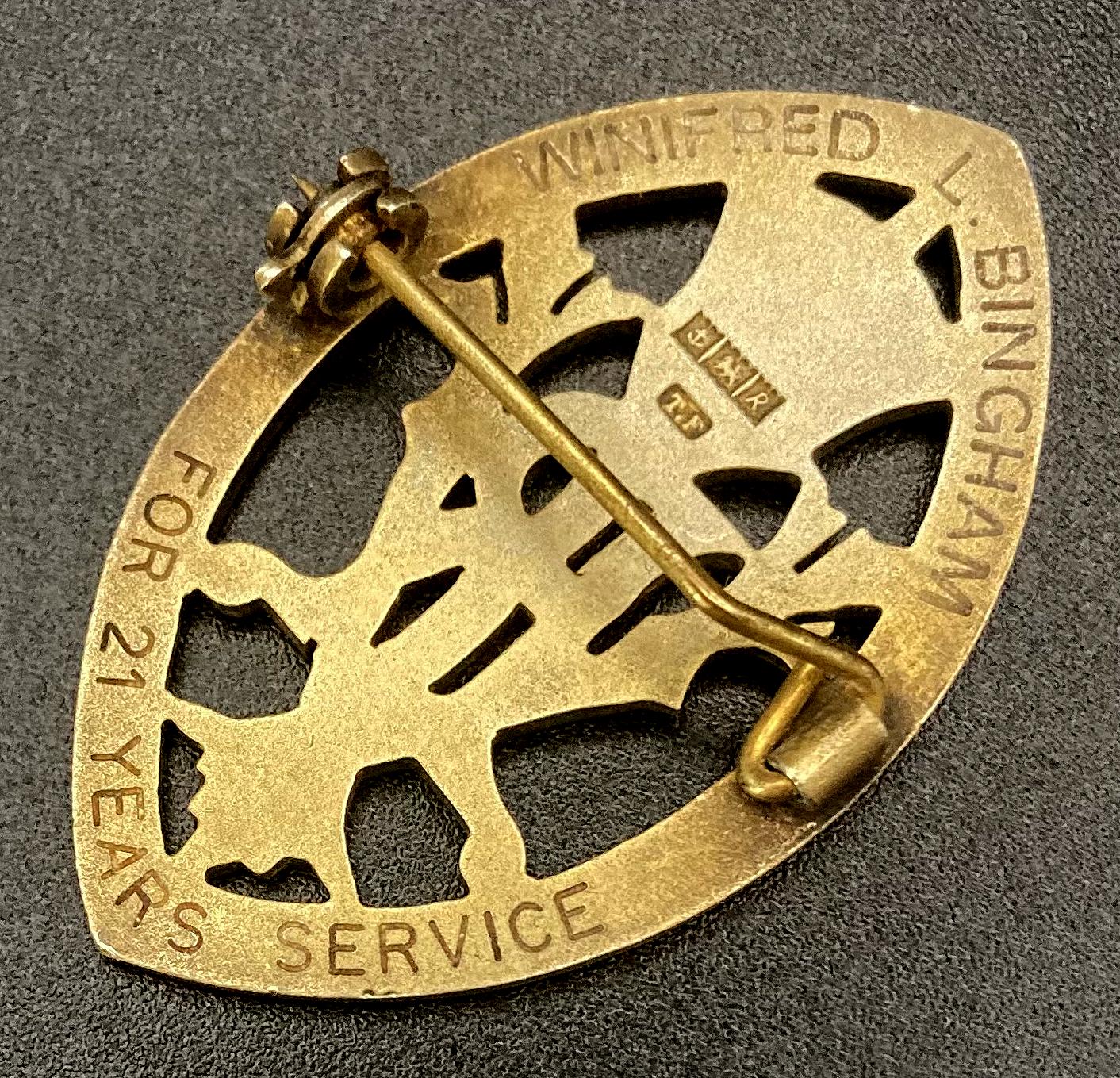 Other angled view of reverse of Queen's Institute of District Nursing badge presented to Winifred L. Bingham