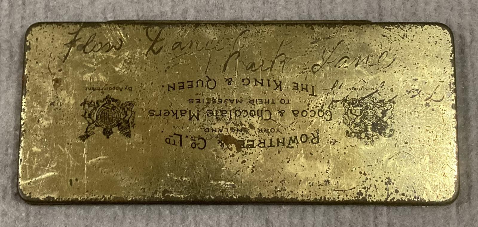 Underside of souvenir chocolate tin - Coronation of King George V and Queen Mary (1911) showing writing