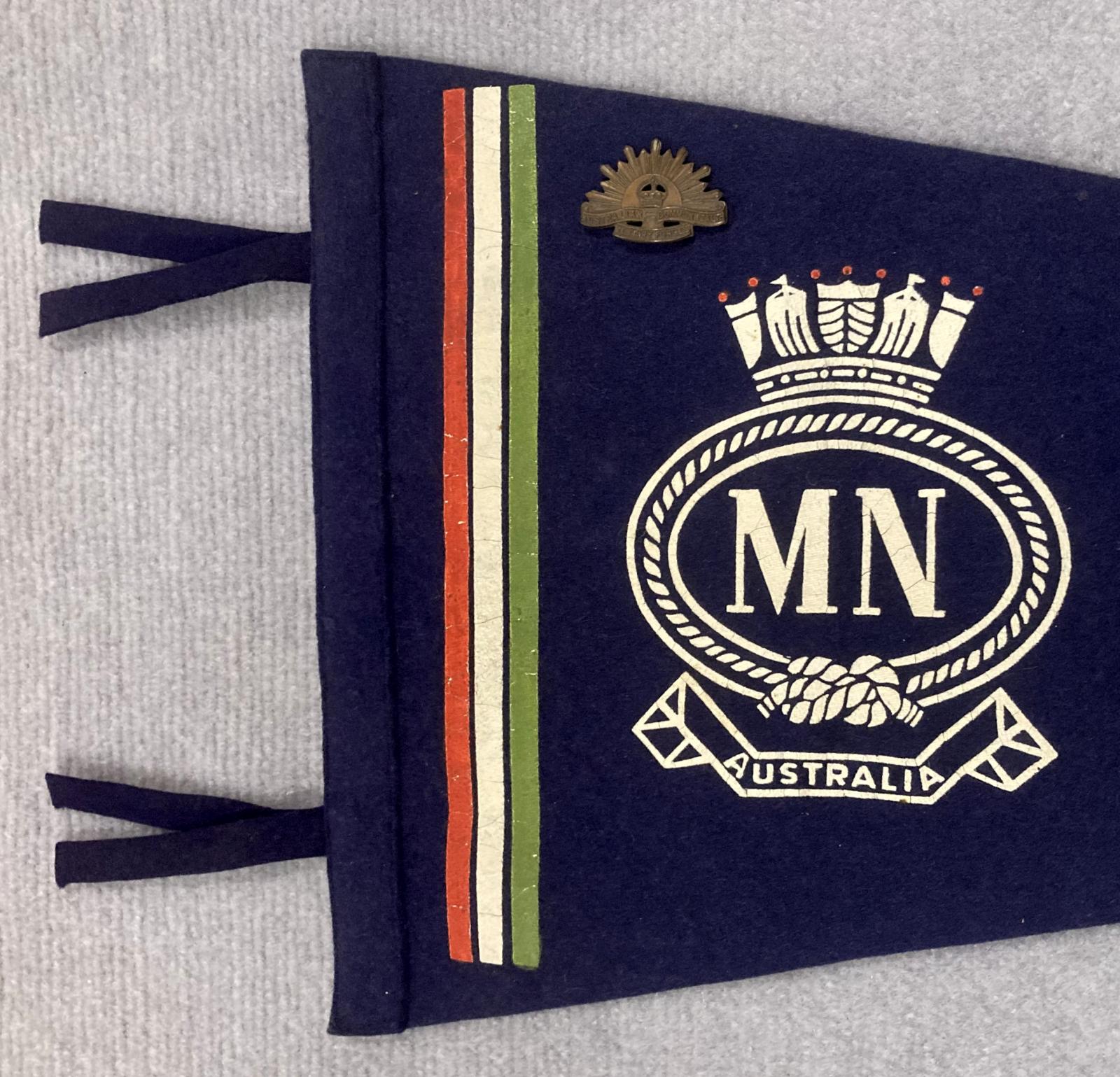 Close up of left end of souvenir felt naval pennant with attached badges - Merchant Navy 