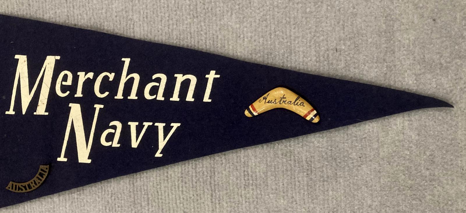 Close up of right end of souvenir felt naval pennant with attached badges - Merchant Navy 