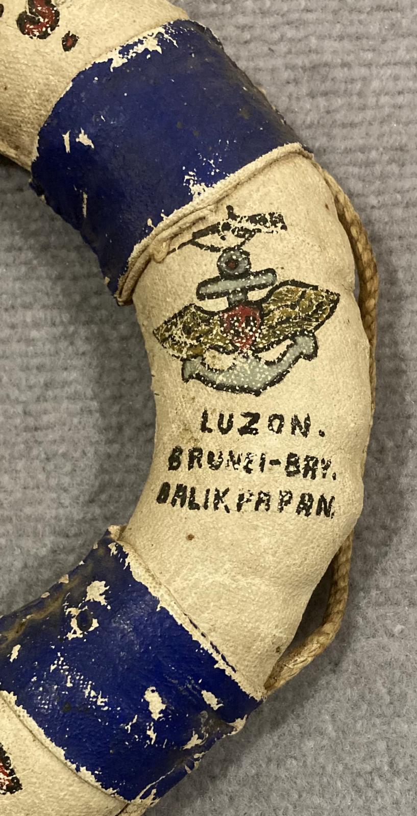 Close up of writing on right side of souvenir miniature naval lifebuoy - HMAS Kanimbla - 1