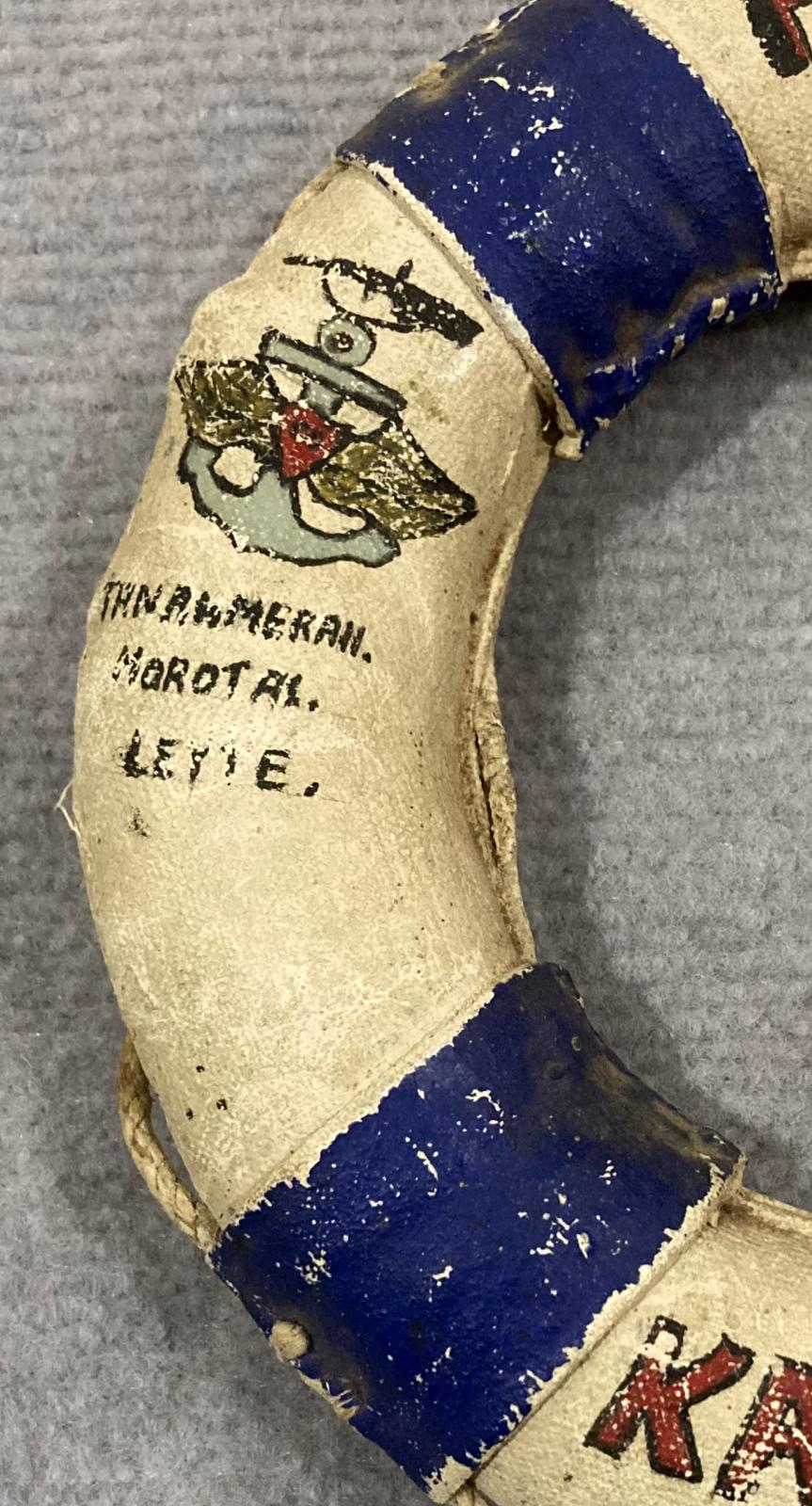 Close up of writing on left side of souvenir miniature naval lifebuoy - HMAS Kanimbla - 1