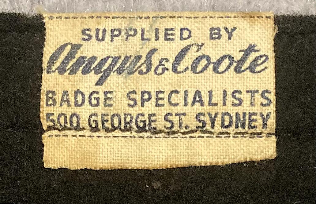 Close up of tag on reverse of souvenir felt pennant  - TSMV Manoora