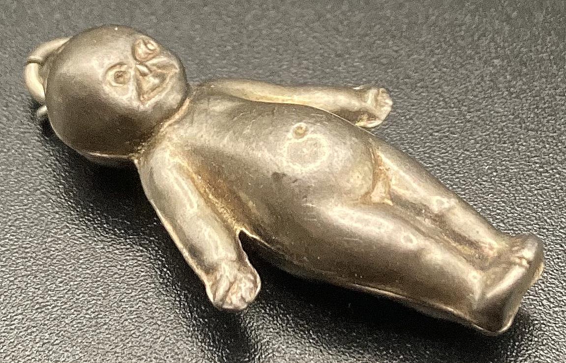 Angled view of sterling silver Fums Up good luck charm