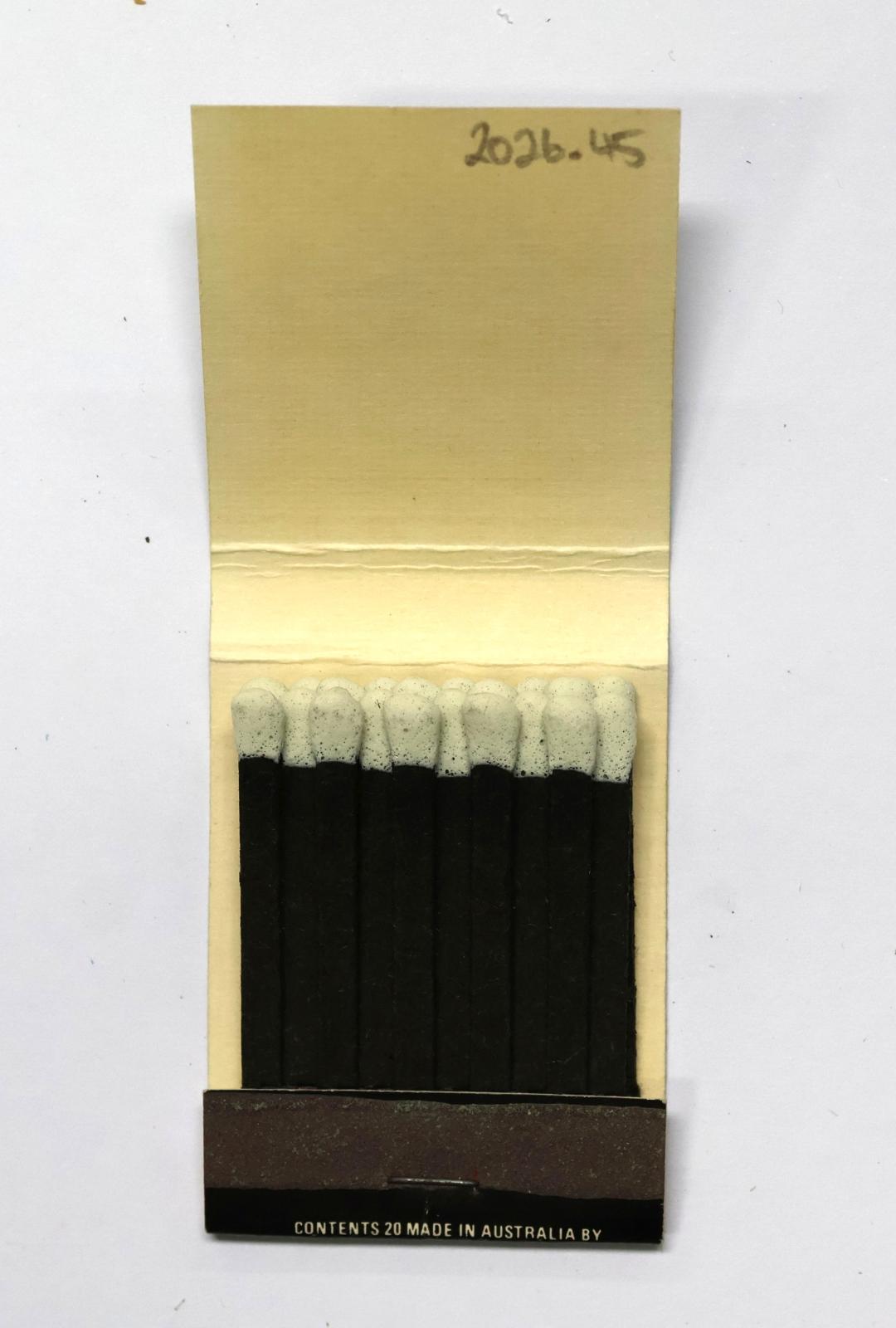The inside has 20 black matchsticks with white match heads.