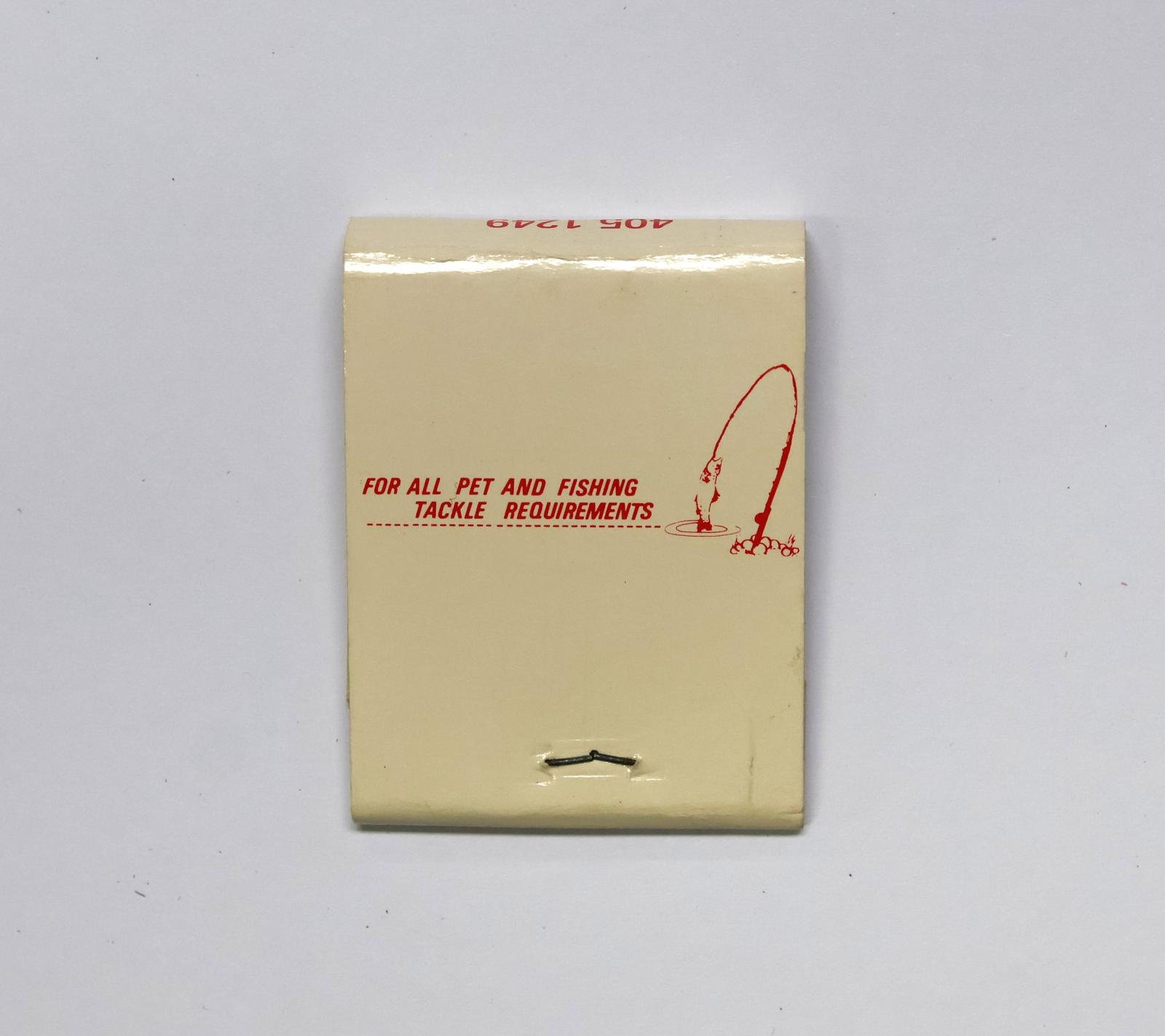 Rectangular shaped matchbook with white background and red text. The front of the matchbook has red text and a picture of a bird in  tall cage with a cat looking up at it. There is text on the back with a picture of a fish caught on a fishing line. 