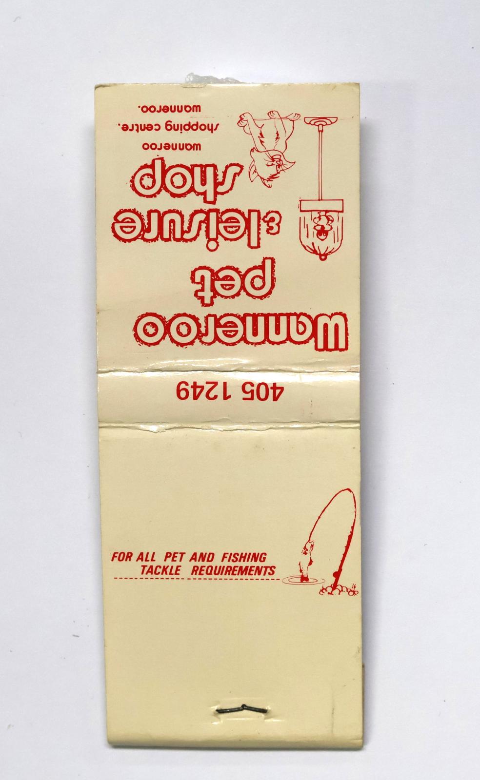 Rectangular shaped matchbook with white background and red text. The front of the matchbook has red text and a picture of a bird in  tall cage with a cat looking up at it. There is text on the back with a picture of a fish caught on a fishing line. The front has a grey igniting panel.