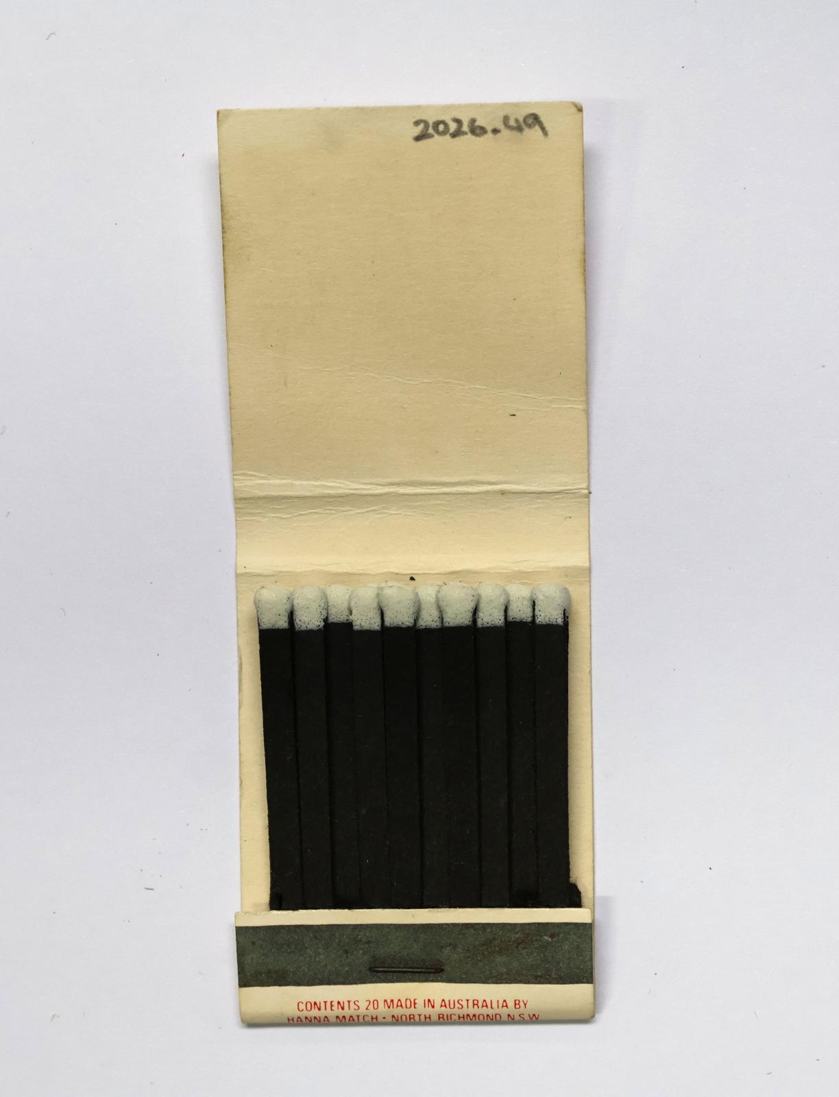 The inside has 18 black matchsticks with white match heads.